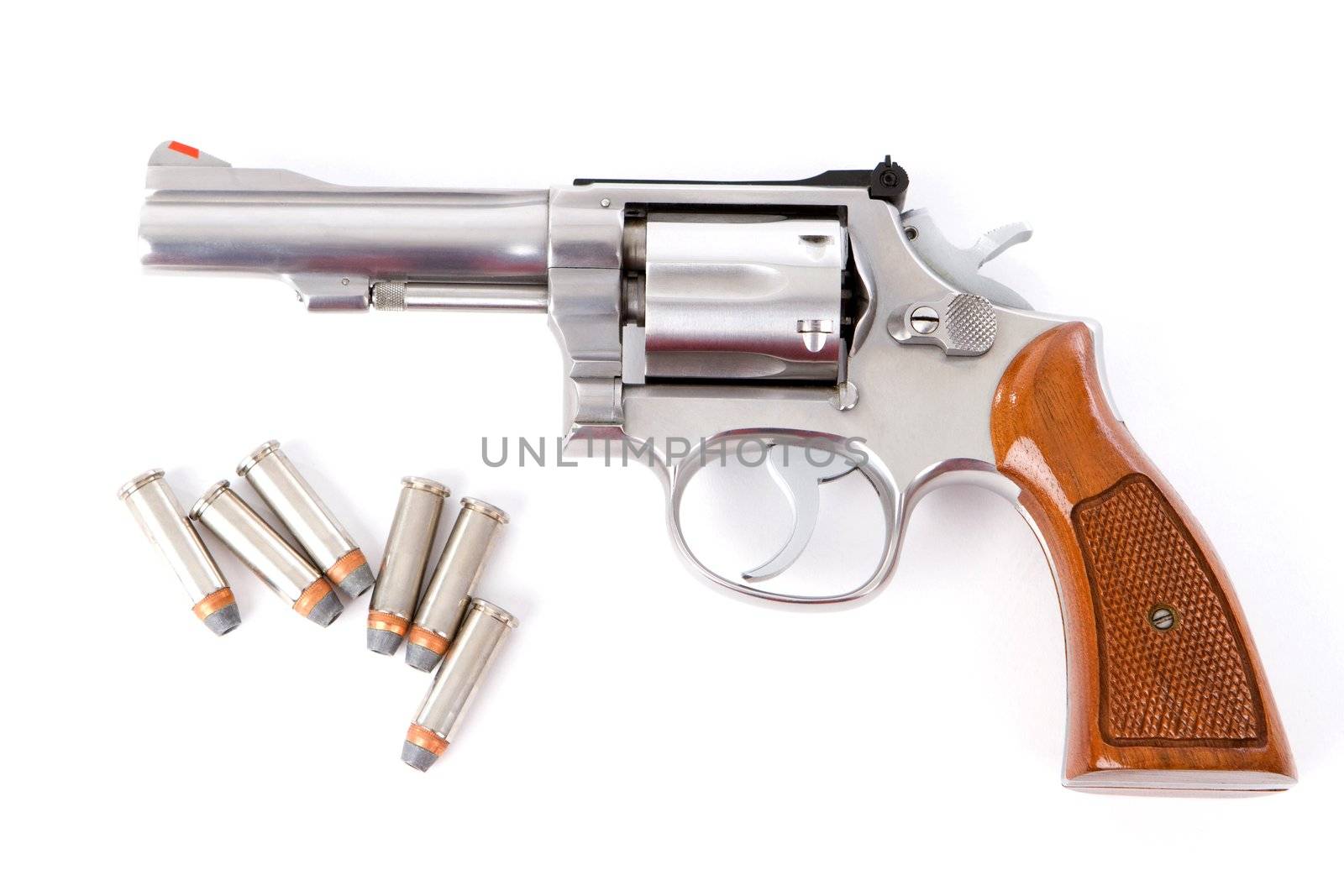 A chrome .38 police special revolver handgun with six hollow point bullets on a white background.