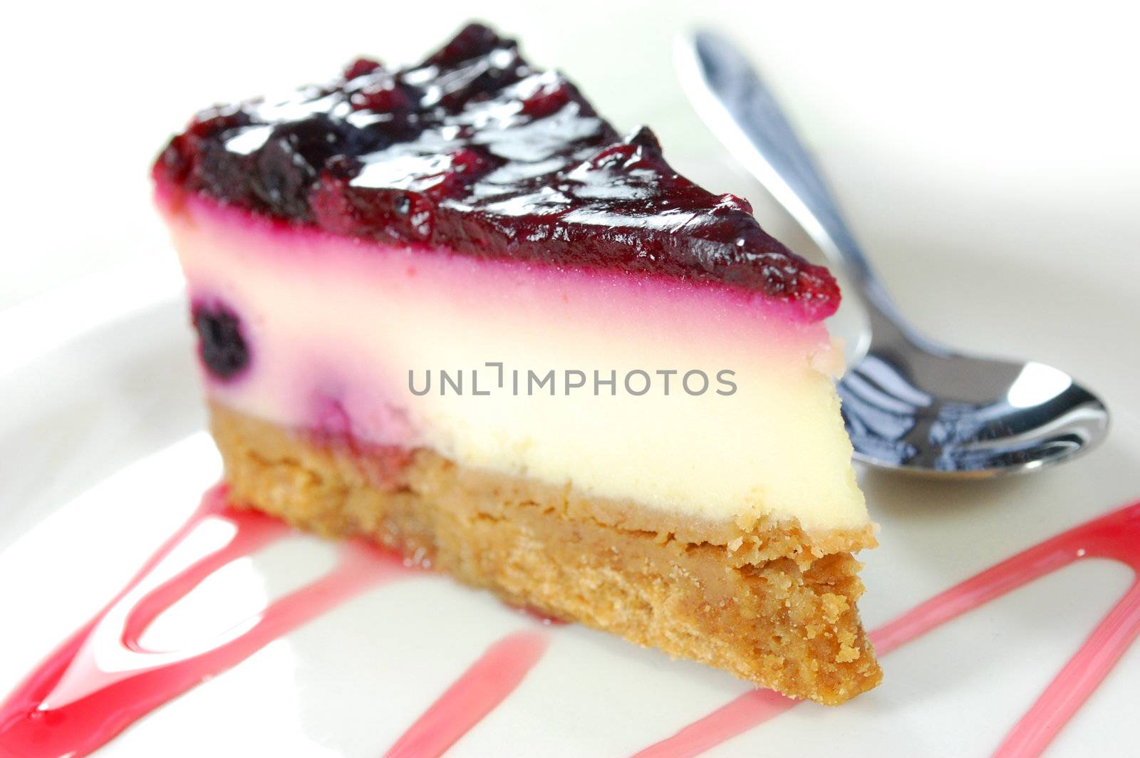 Berry topped cheesecake with strawberry syrup
