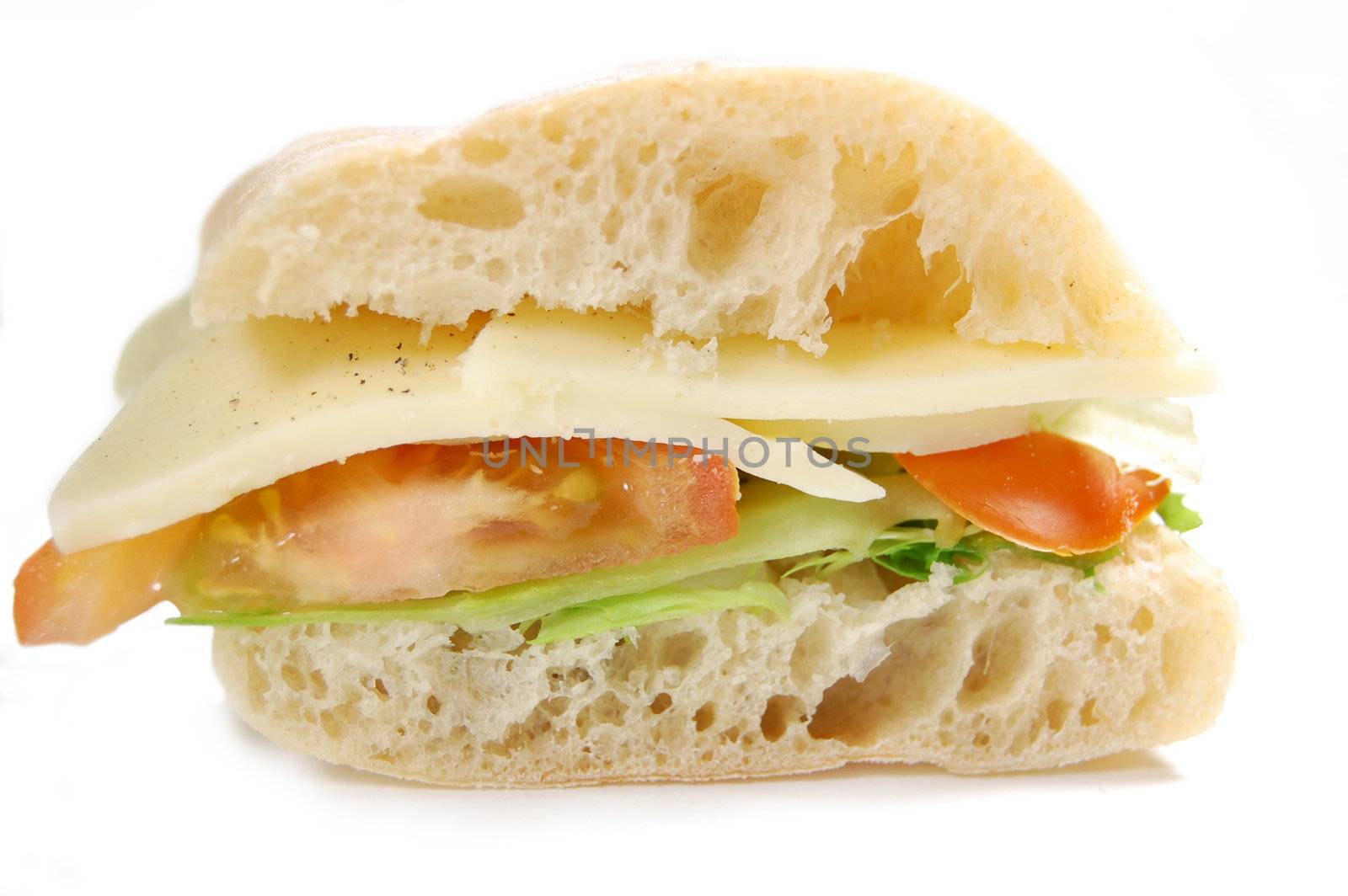 Closeup of a sliced ciabatta sandwich with mozzarella