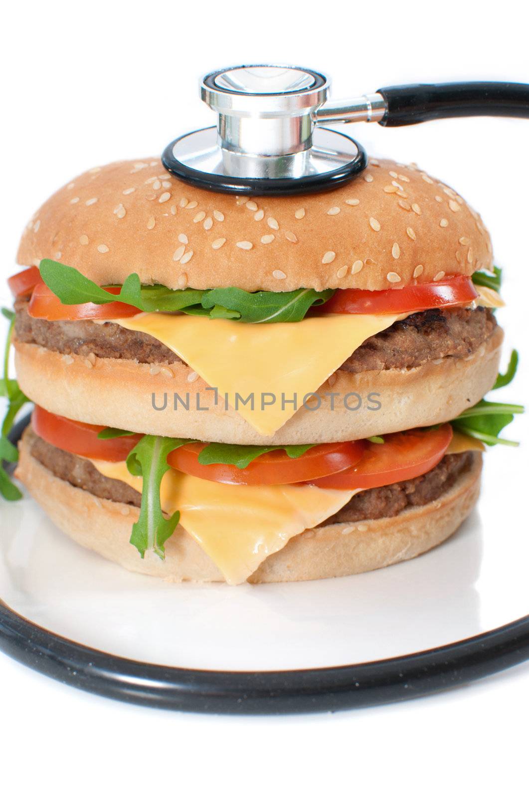 Unhealthy burger with stethoscope by unikpix
