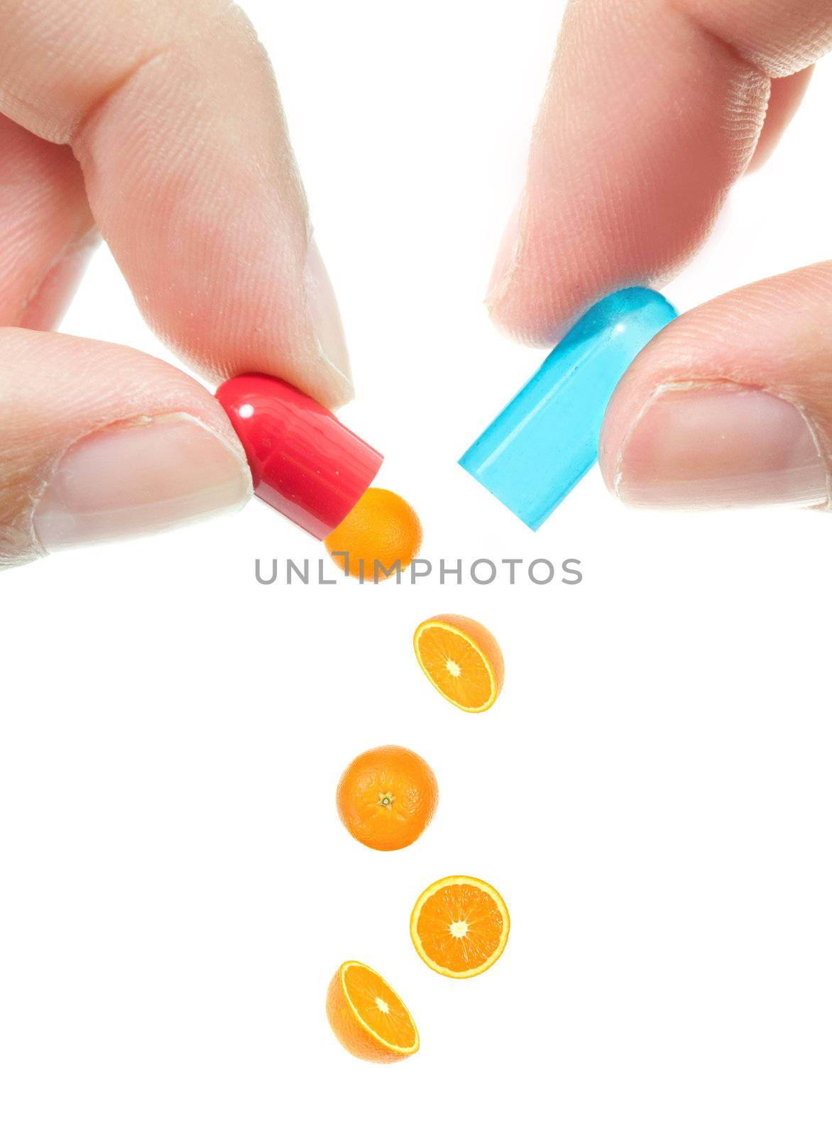 Conceptual image of oranges pouring out of an opened pill 