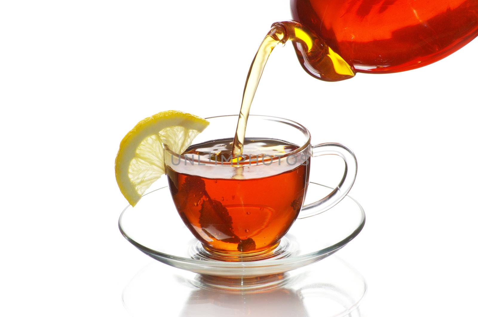 tea being poured into glass tea cup