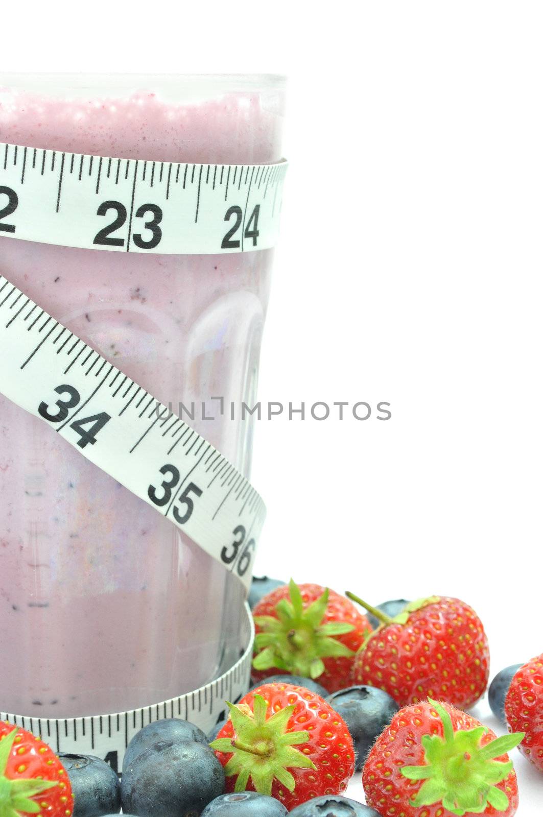 Tape measure wrapped around a blueberry smoothie 