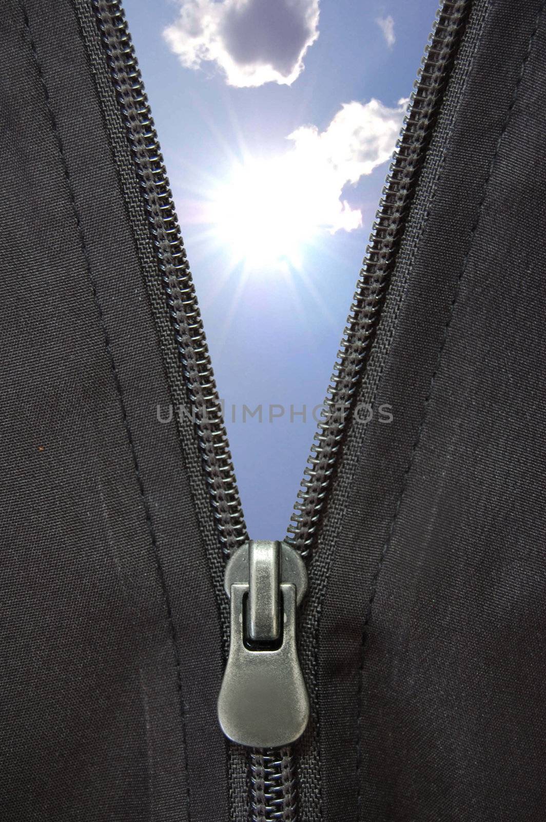 Open zip reveals sun and blue clouds