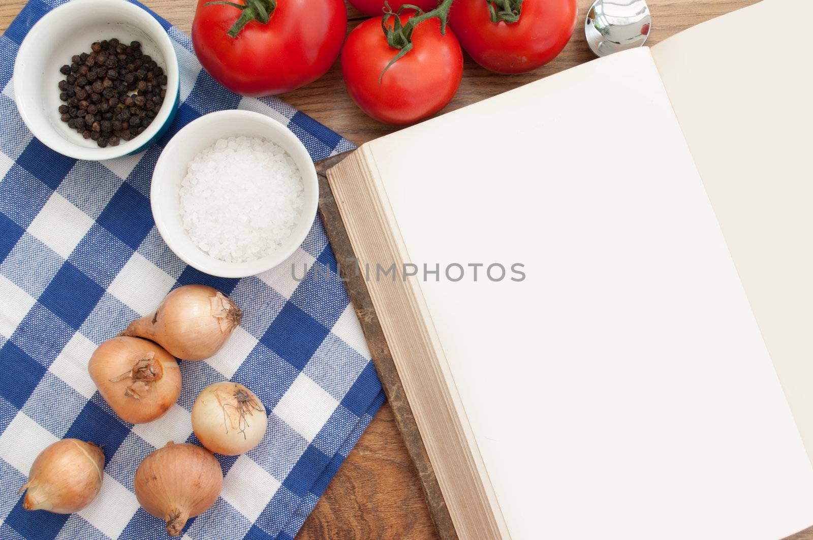 Open blank recipe book surrounded with ingredients 