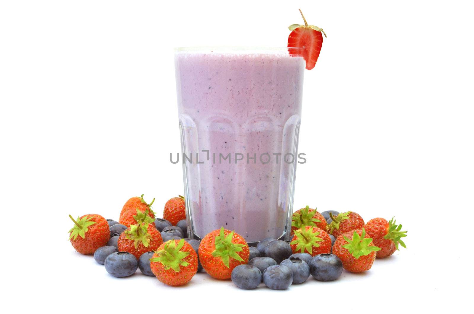 Blueberry flavoured smoothie surrounded with berries 