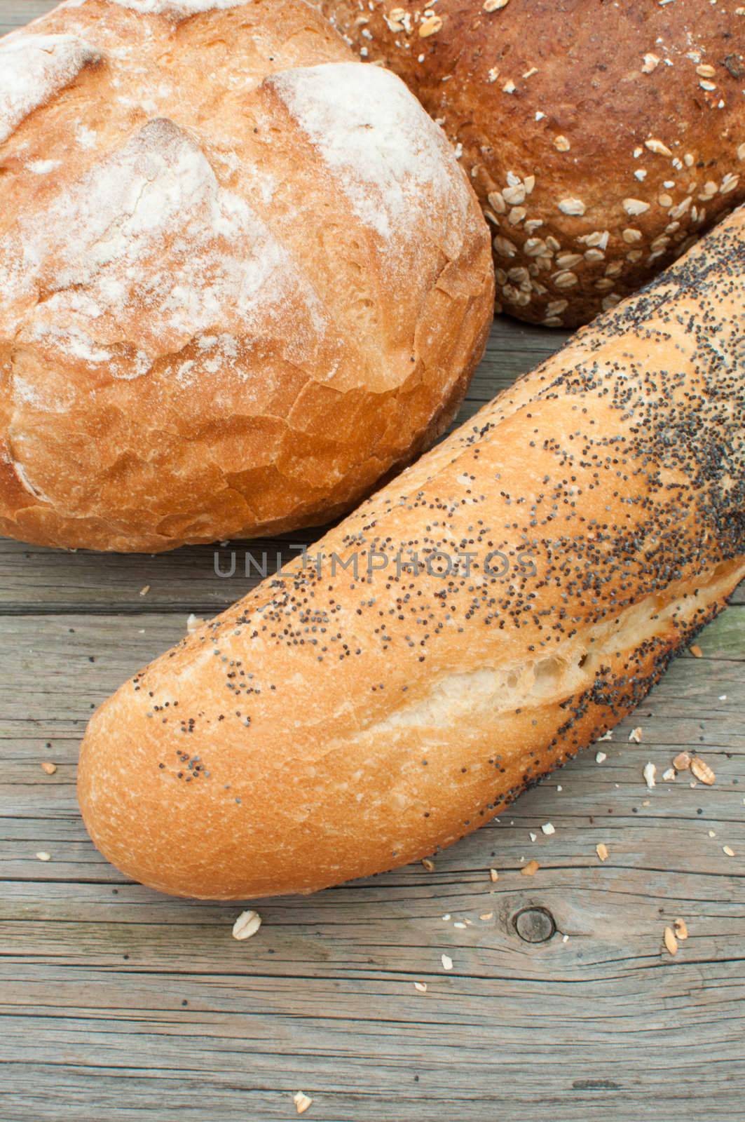 Closeup of round, seeded bread loaves and french baguette