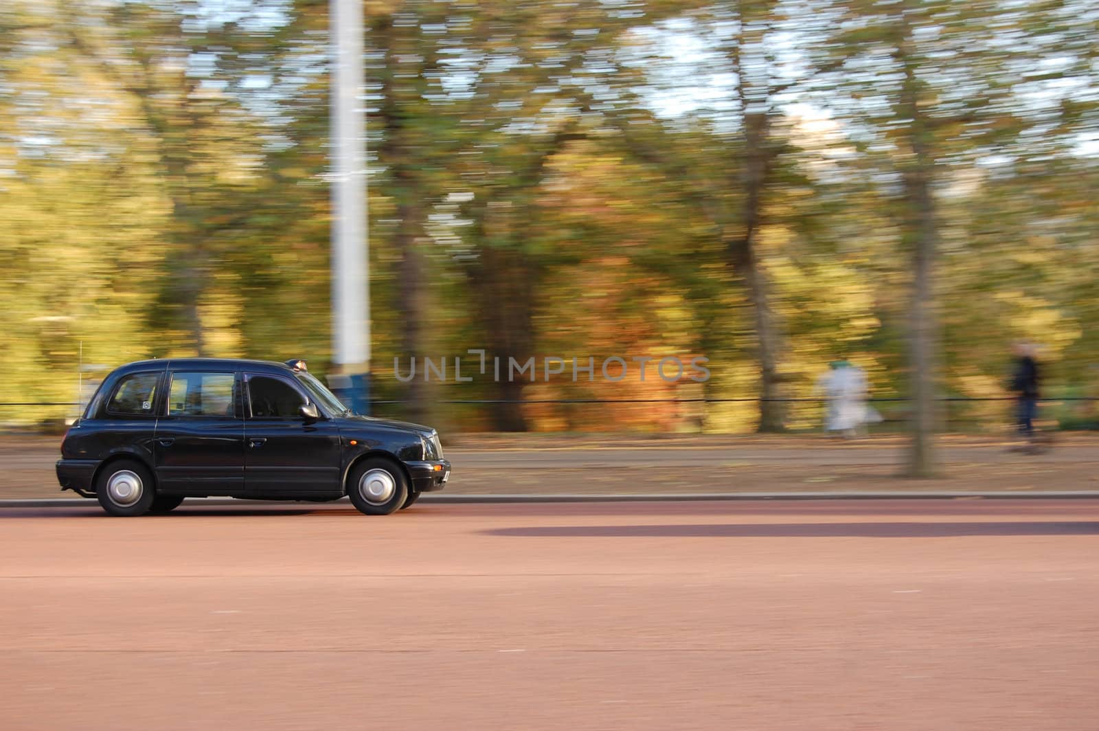 London cab driving through St James Park 