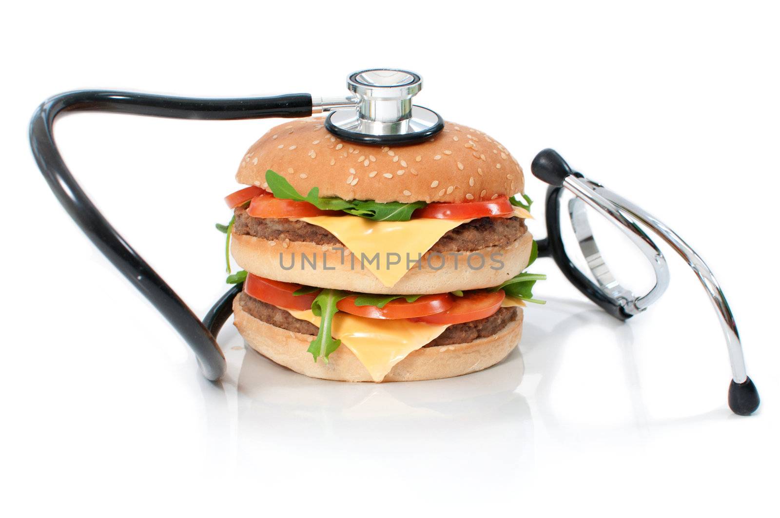 Stethoscope around an unhealthy double cheeseburger  