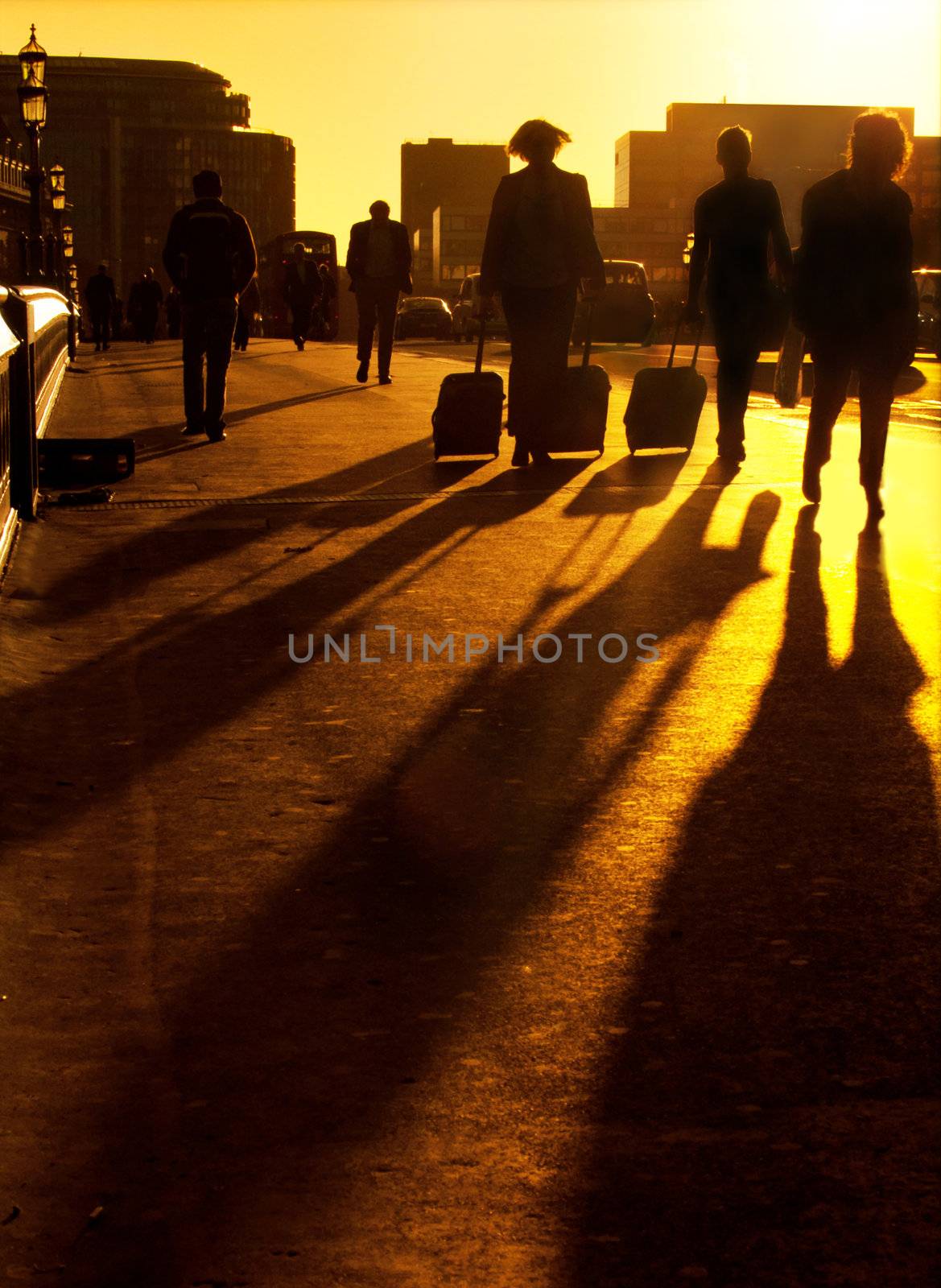 Silhouette of business people and commuters travelling to work at sunrise 