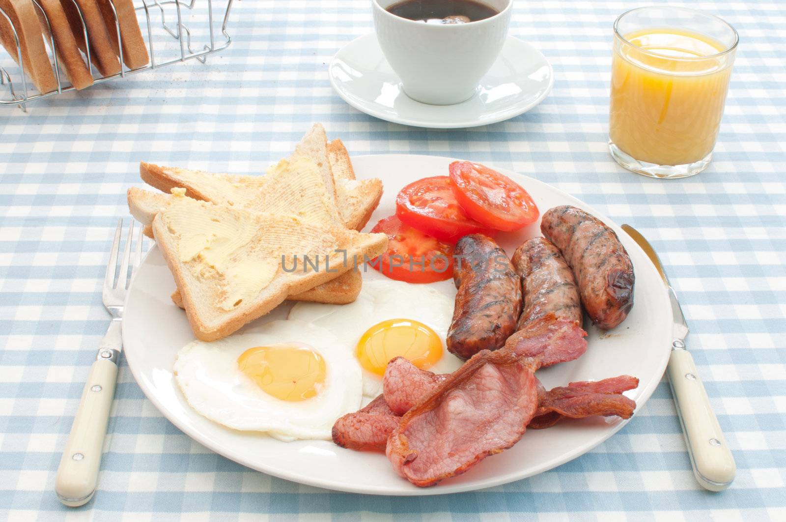Delicious english breakfast fry up with sausages, eggs and bacon