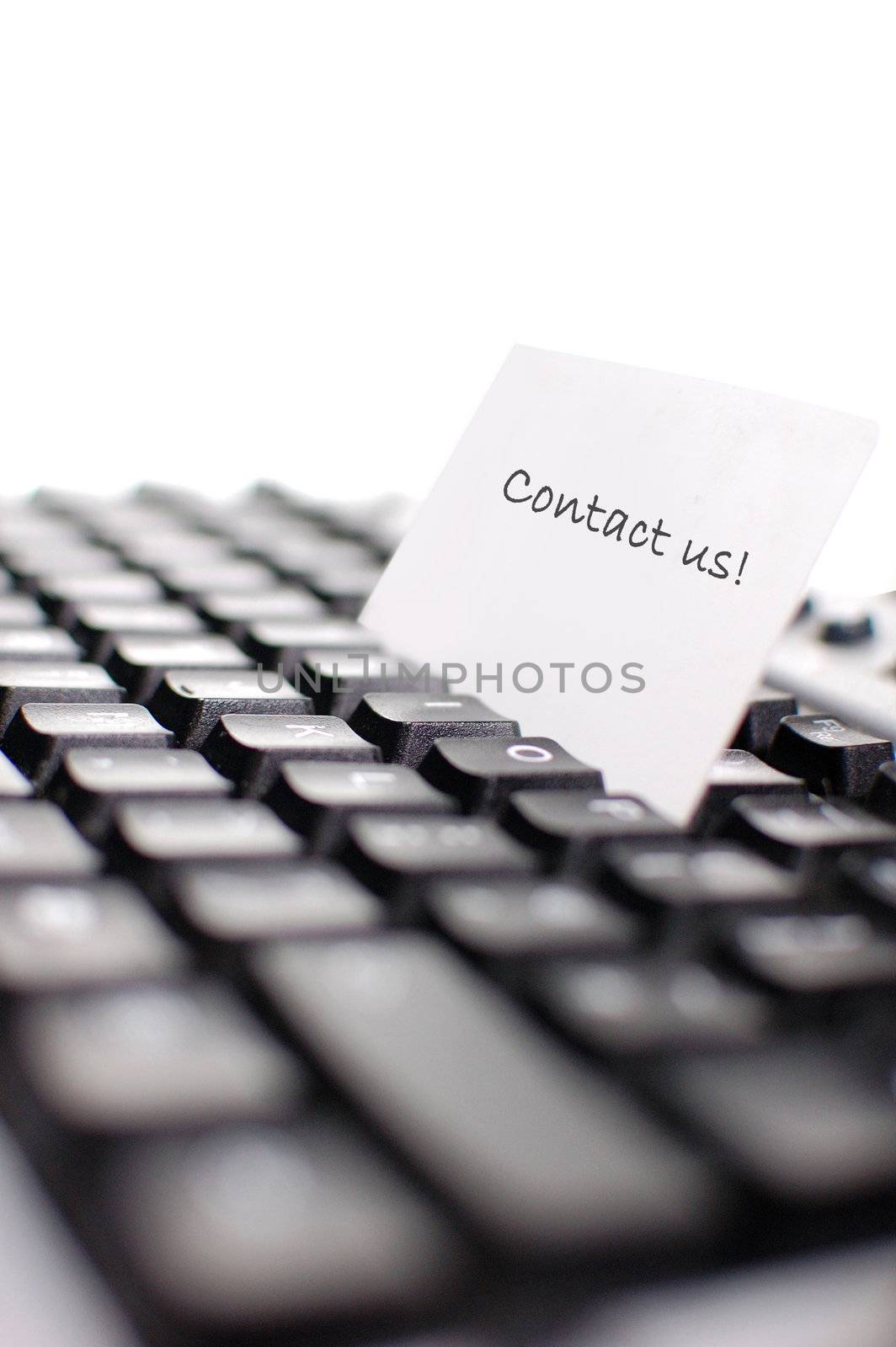 Business card on top of a computer keyboard (shallow depth of field)