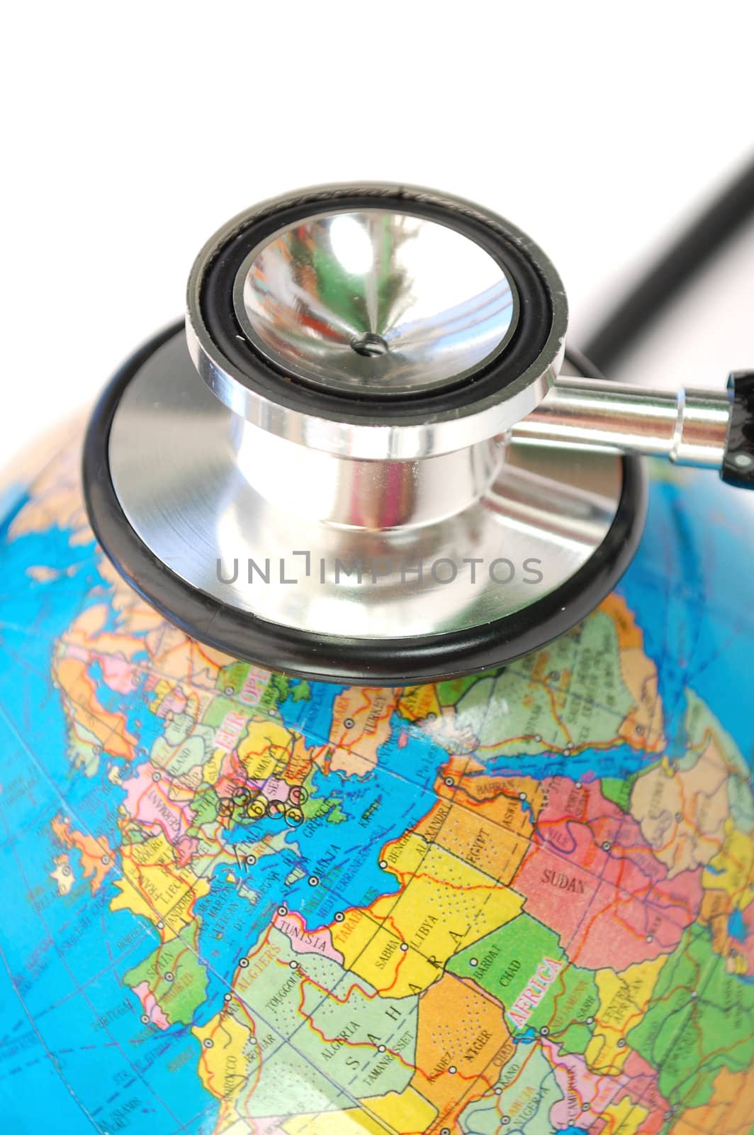 Stethoscope on top of an atlas globe