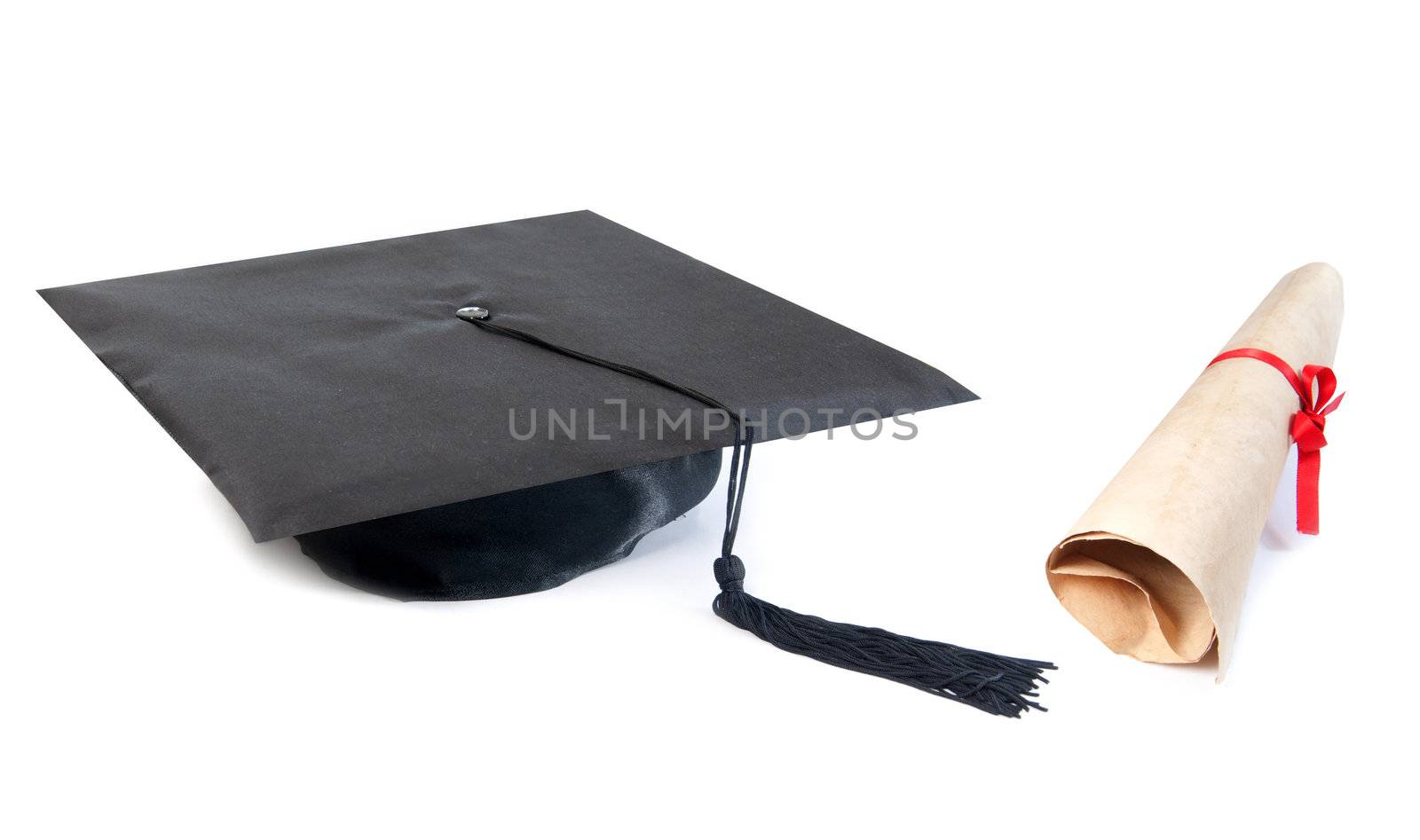 Graduation hat and paper scroll over a white background