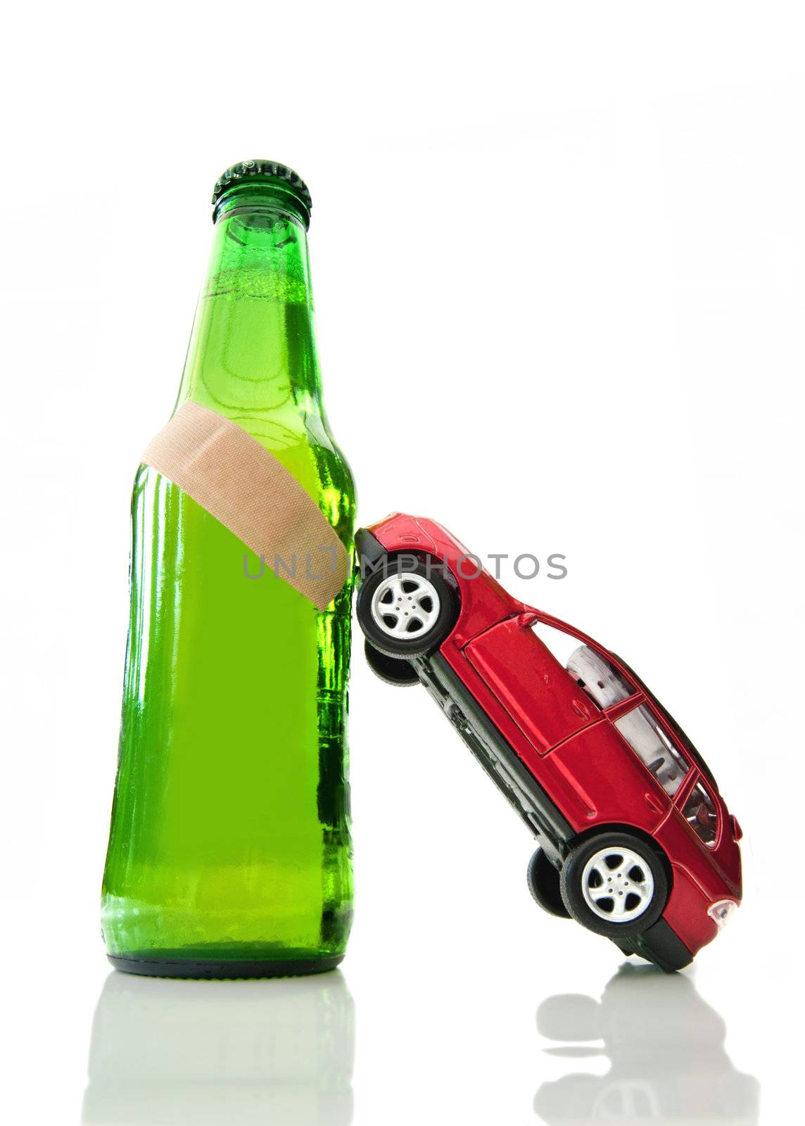Miniature car leaning against a beer bottle with a band aid