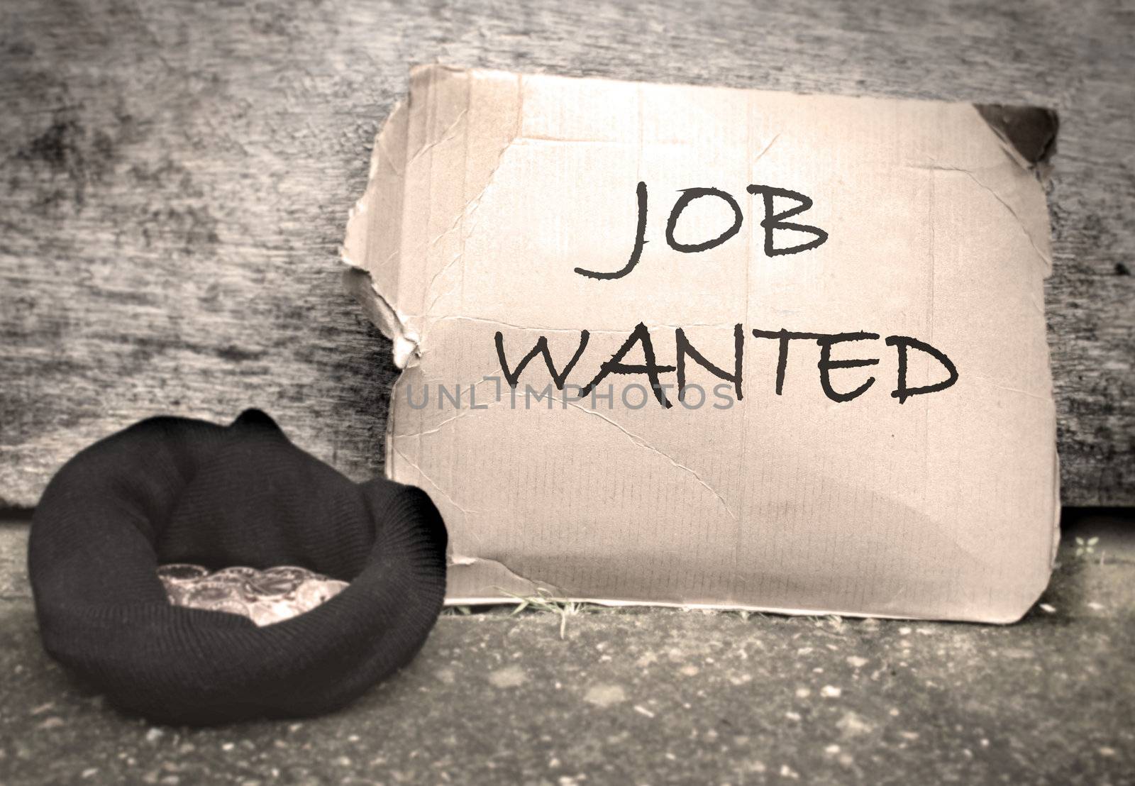 Job wanted sign written on a piece of cardboard