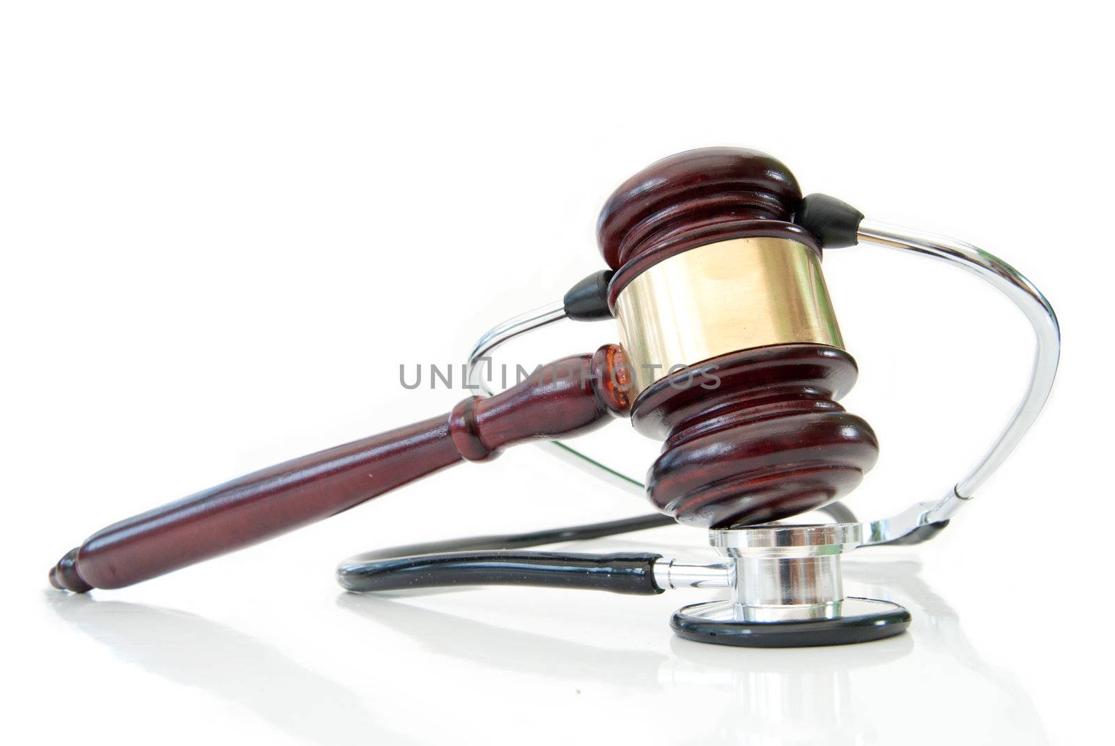 Stethoscope wrapped around a gavel over a white background