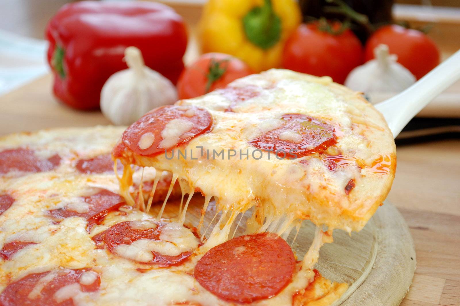 Slice of pepperoni with melted cheese 
