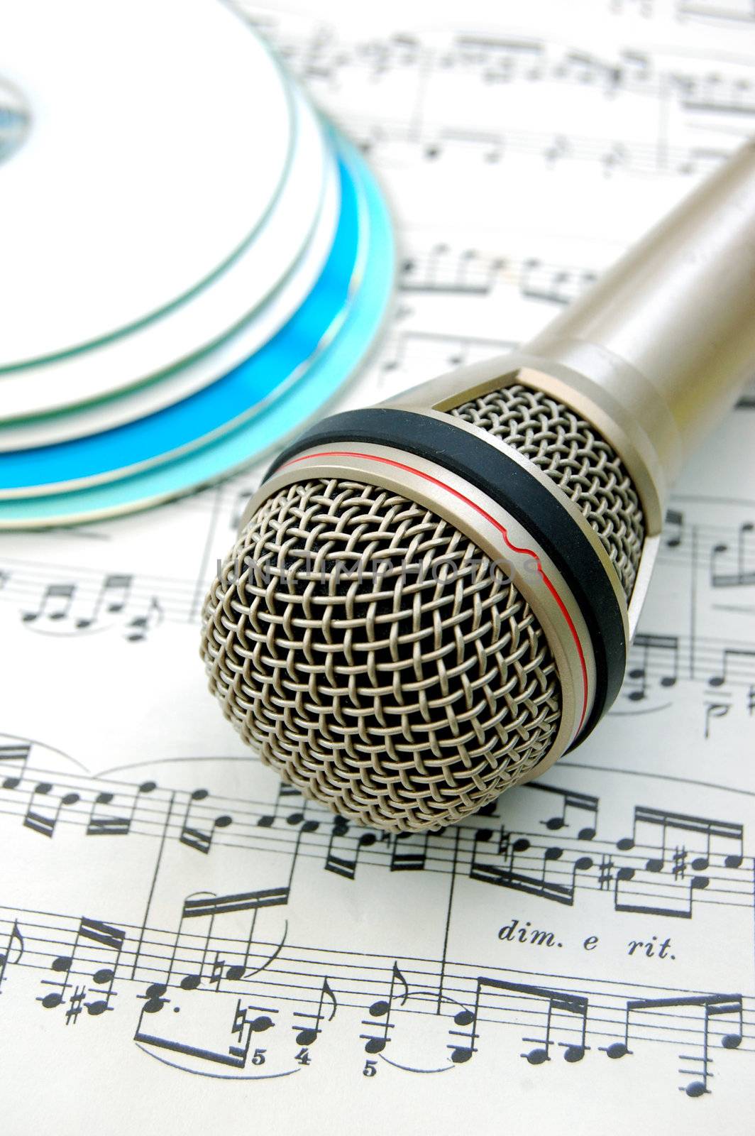 Microphone with music sheet and several cds