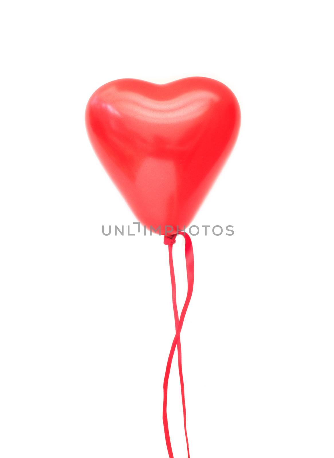 Red heart shaped floating air balloon over a white background
