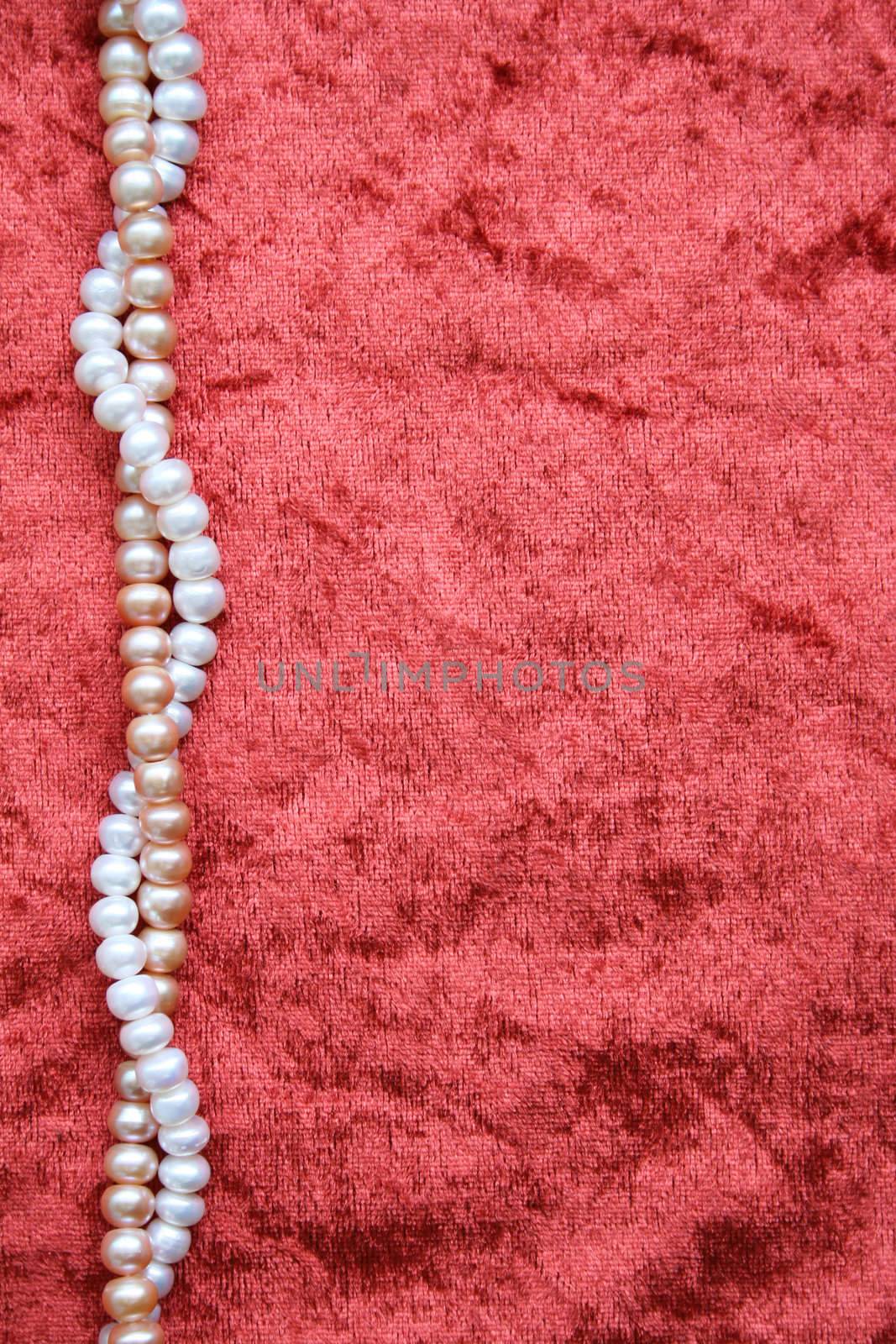 White and pink pearls on the terracotta velvet can use as background