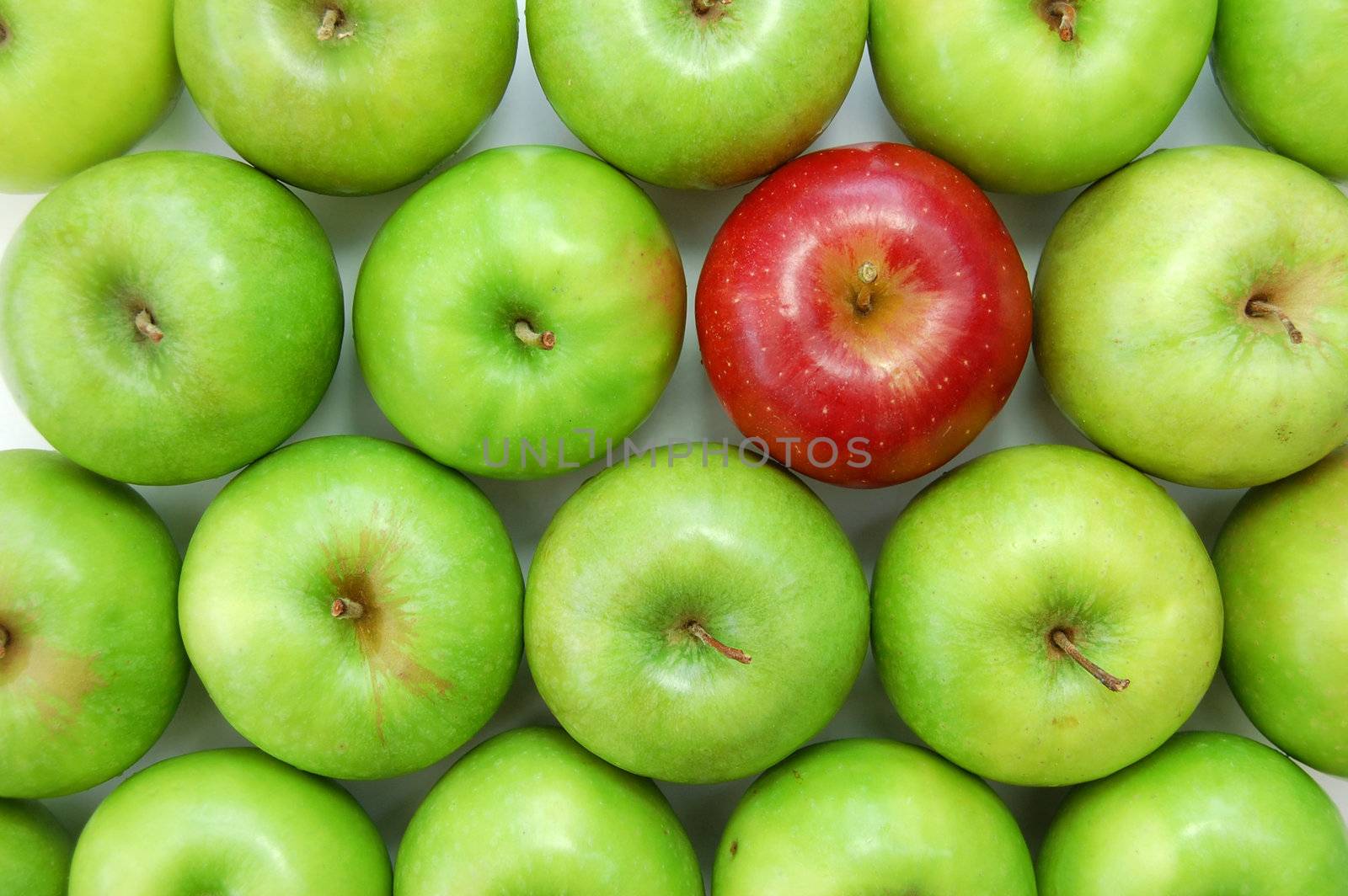 Red apple amongst many green ones