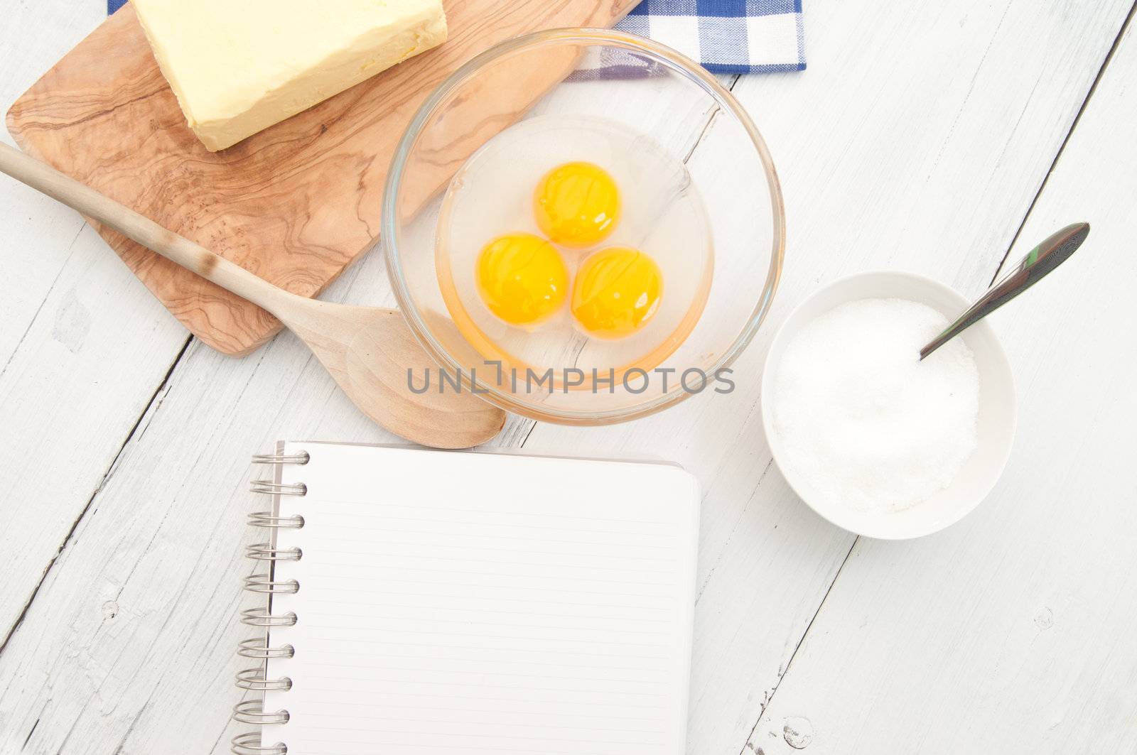 Blank recipe book surrounded with ingredients 