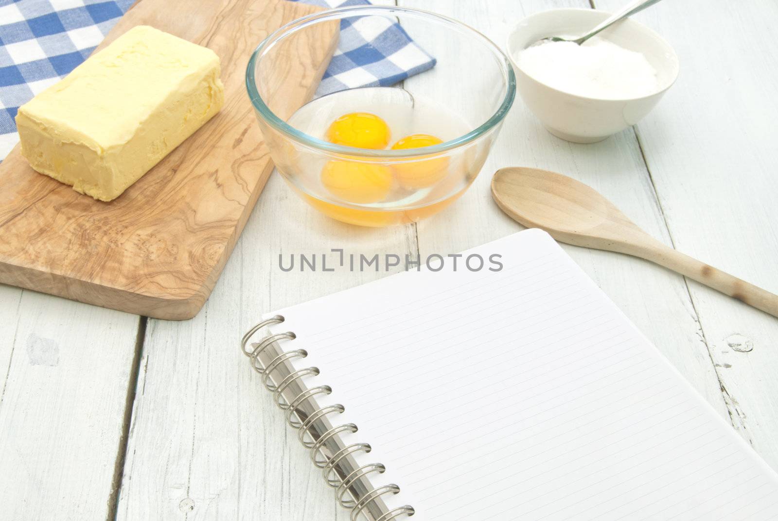 Blank recipe book surrounded with ingredients