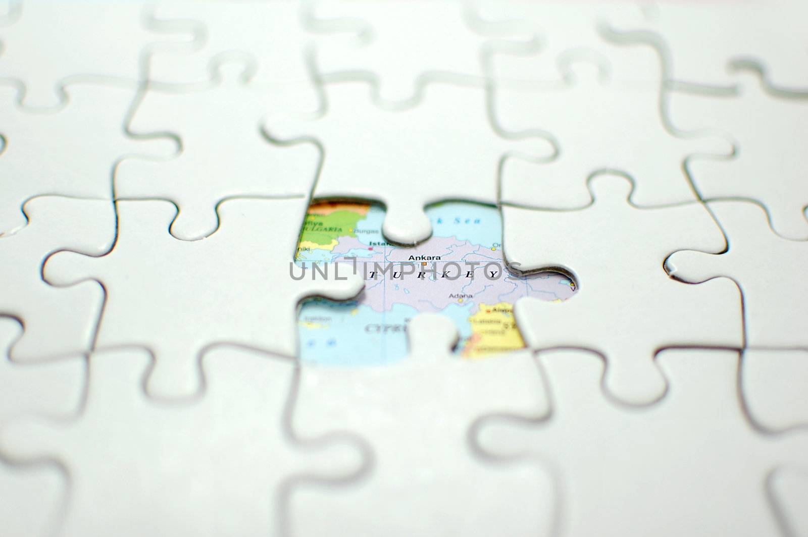 Jigsaw puzzle with missing piece revealing turkey on a map (shallow depth of field)