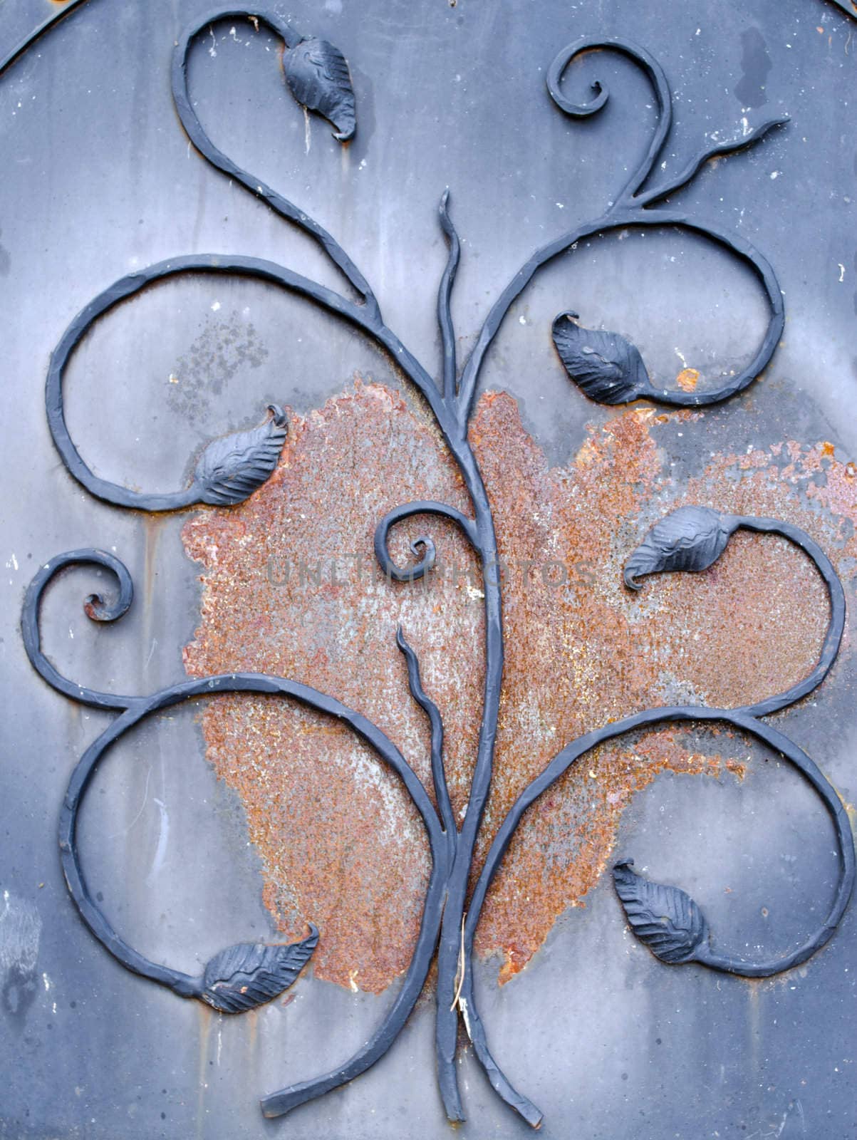 background of retro rusty metal gate closeup with decorations.