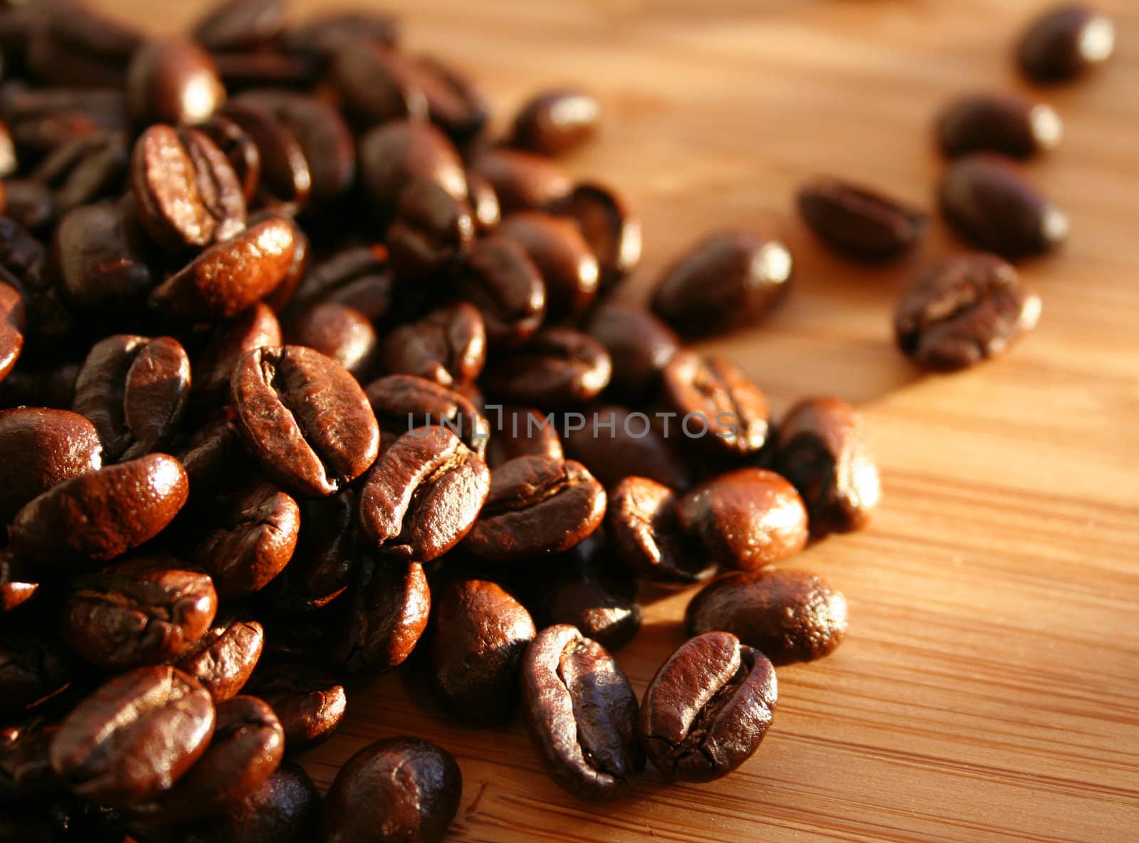 Heap of burnt brown arabica coffee beans 
