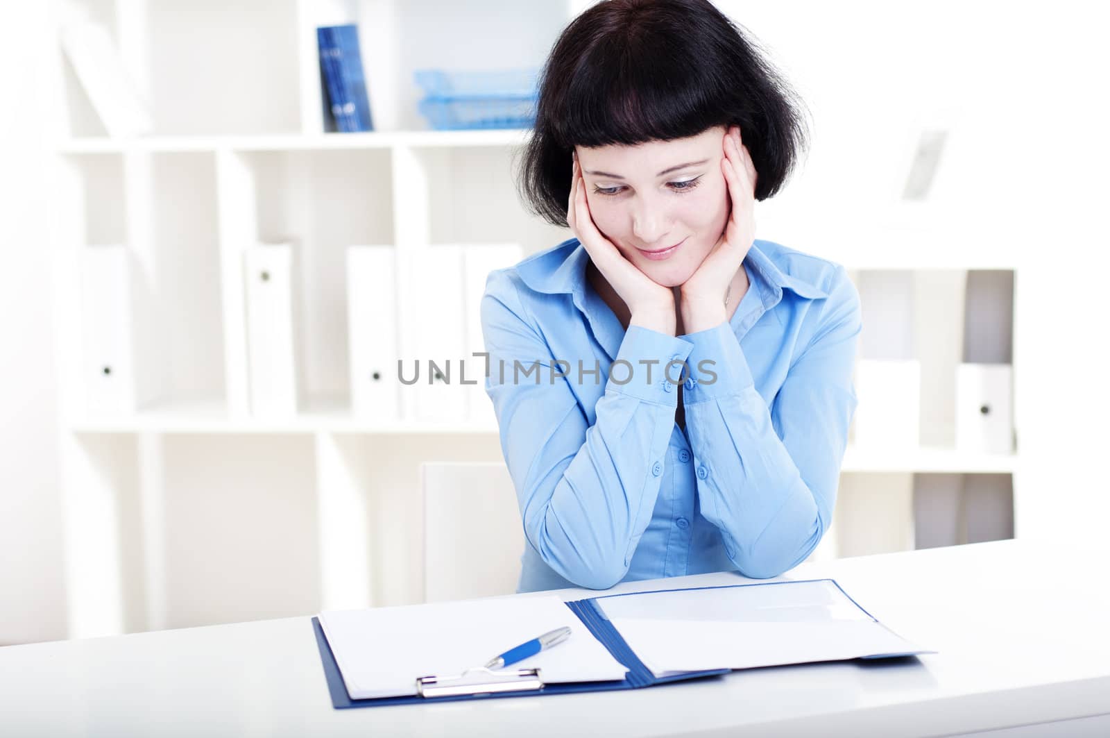 Portrait of a business woman in the office doing some paperwork