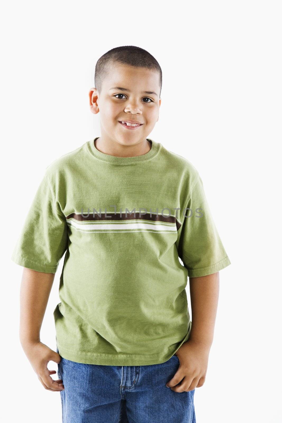 Young latino adolescent boy standing smiling.
