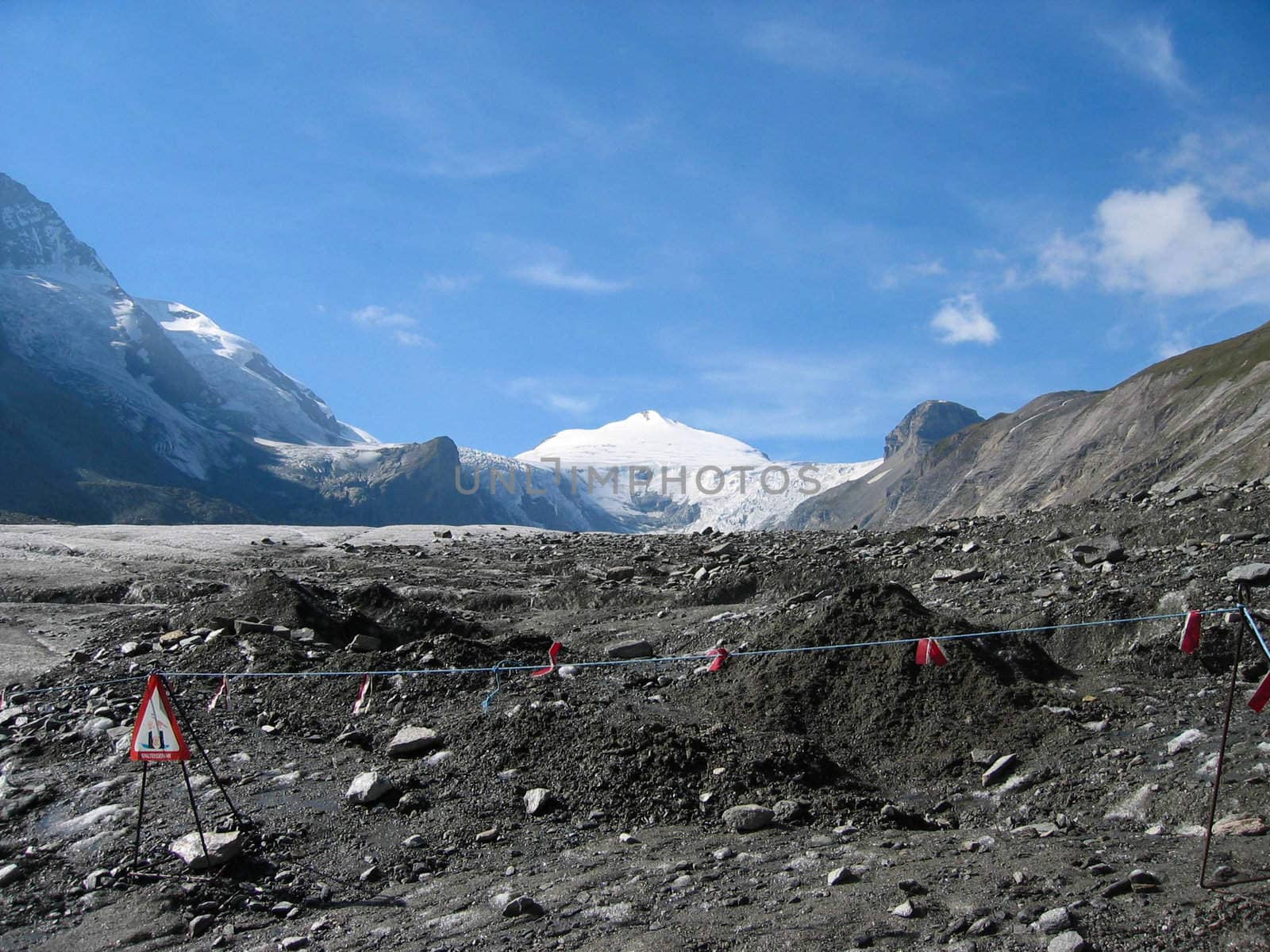 view on the glacier of the grossklockner with warning signs