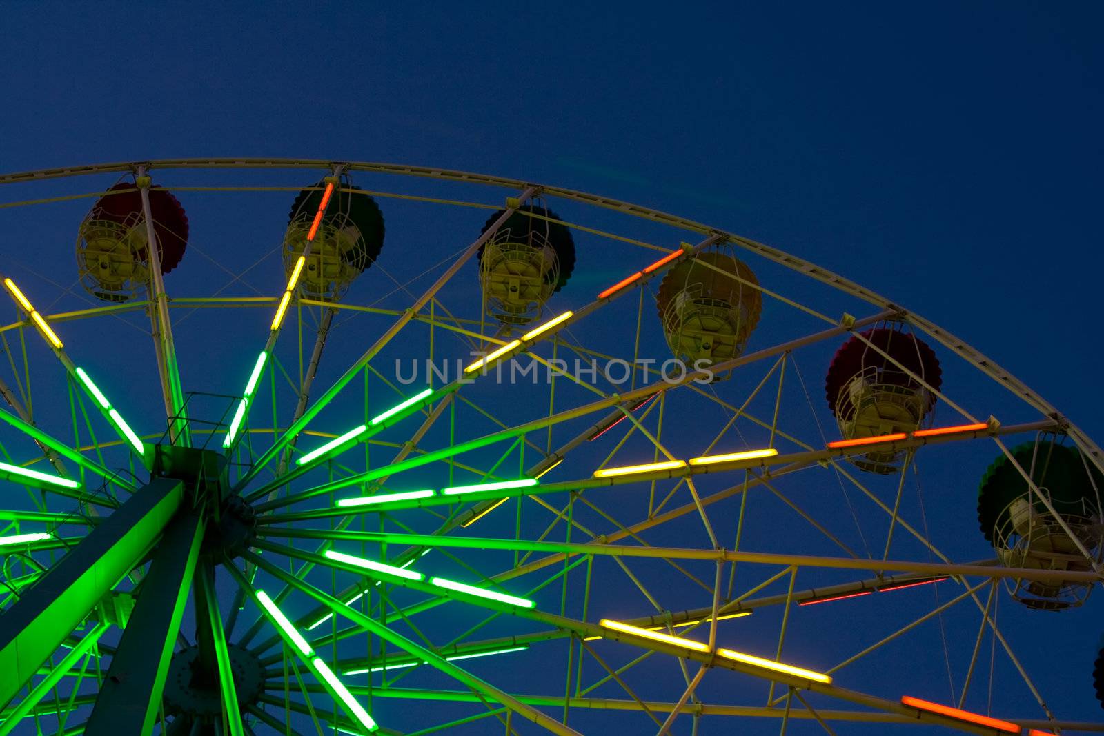 Abstract view of a colourful ferris wheel at night