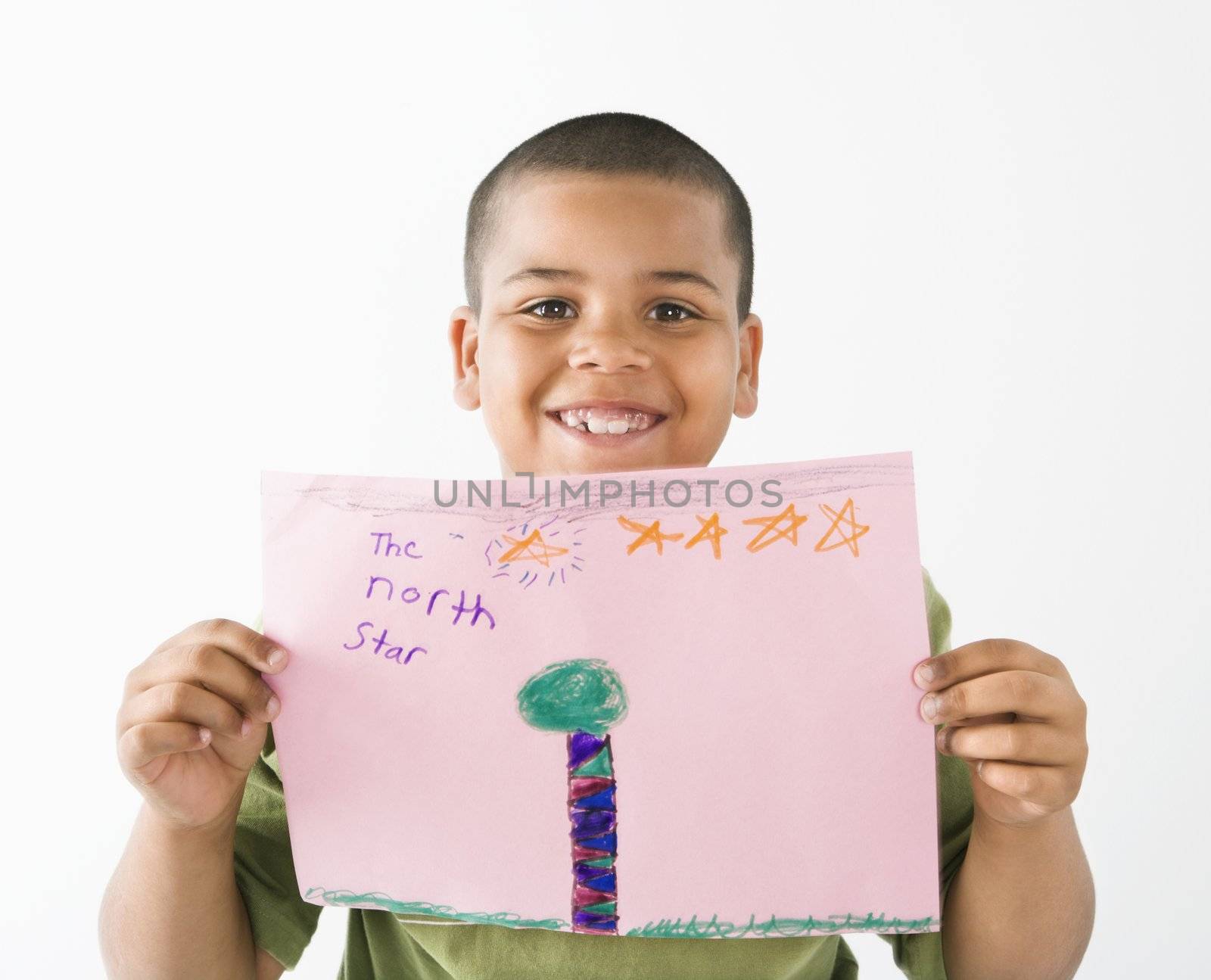 Smiling hispanic boy holding drawing. by iofoto