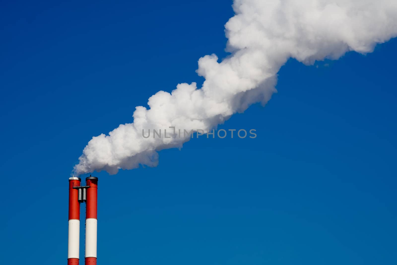 The chimney of a factory with white smoke