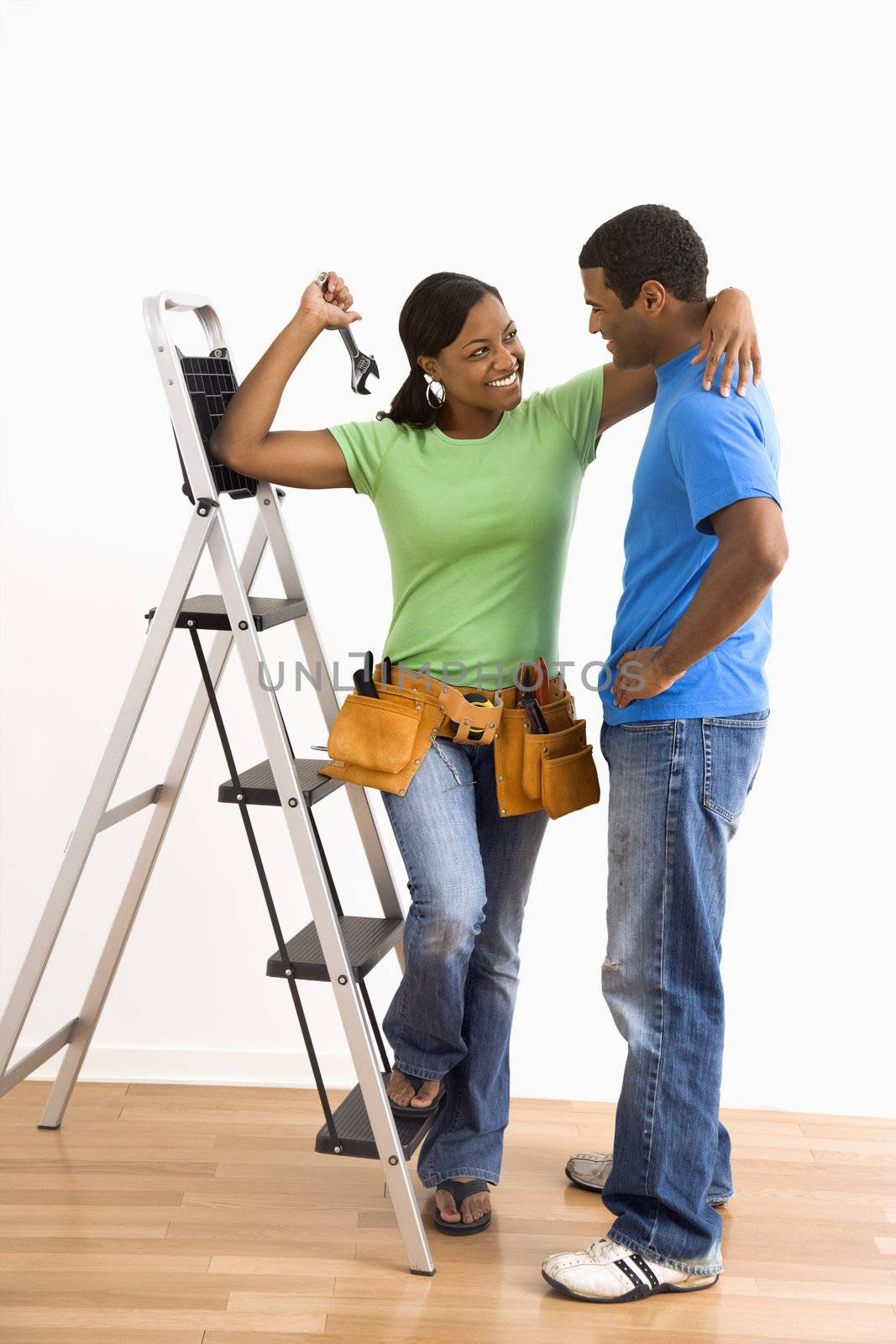 Portrait of couple with ladder. by iofoto
