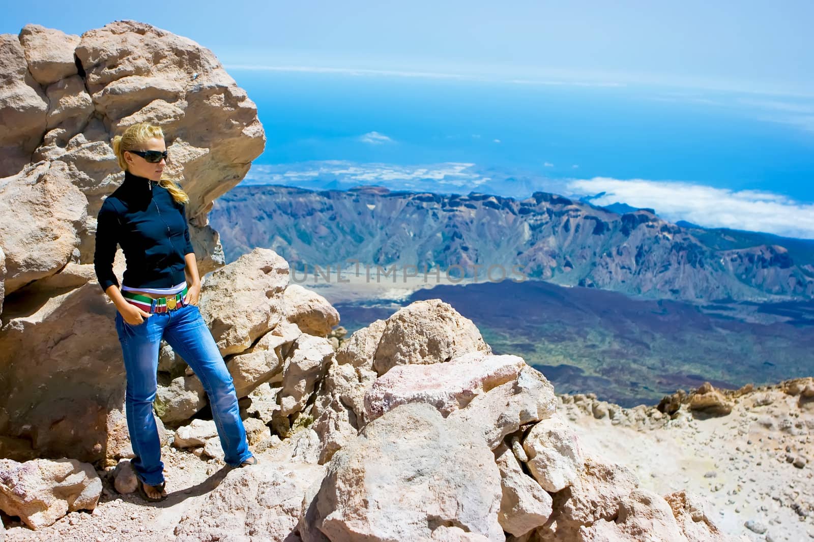 Girl standing on the edge of the volcano