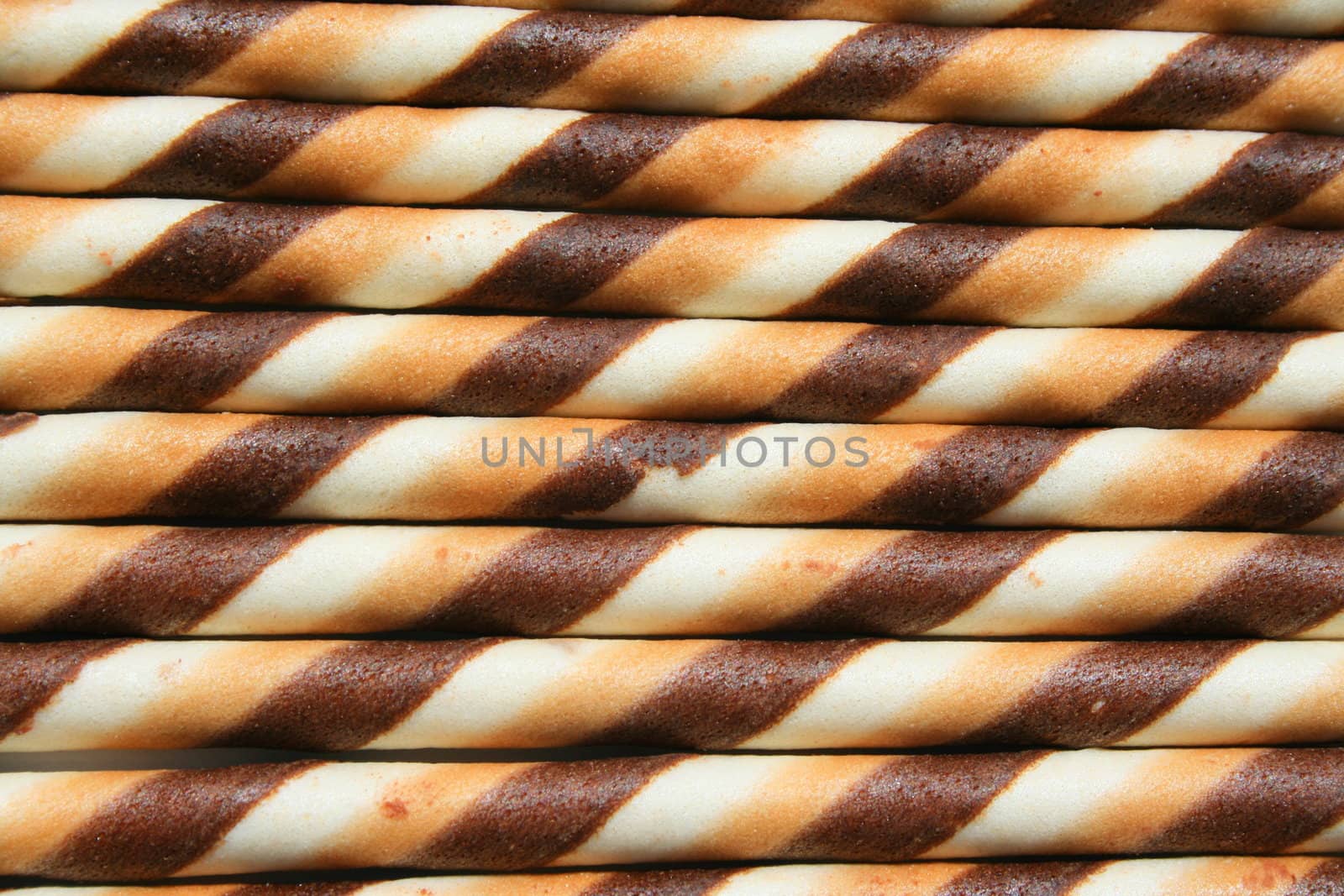 Close up of chocolate cookie sticks on a plate.
