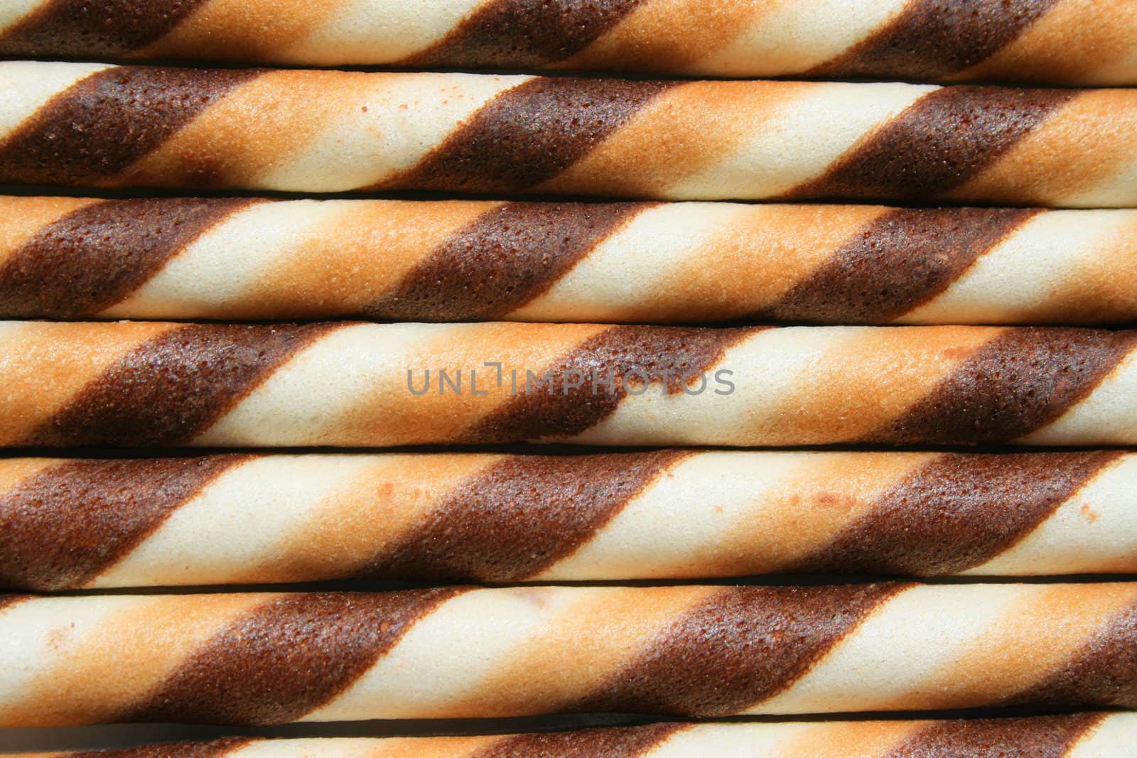 Close up of chocolate cookie sticks on a plate.
