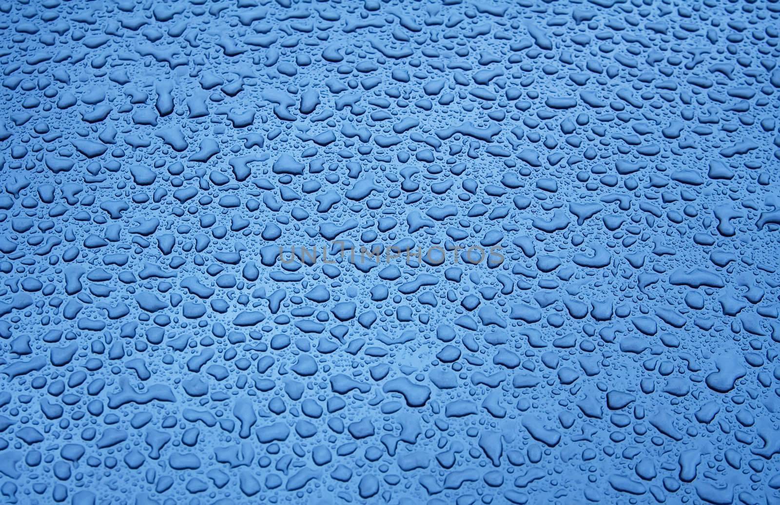 Water Droplets on a Blue Steel Surface. Close-up