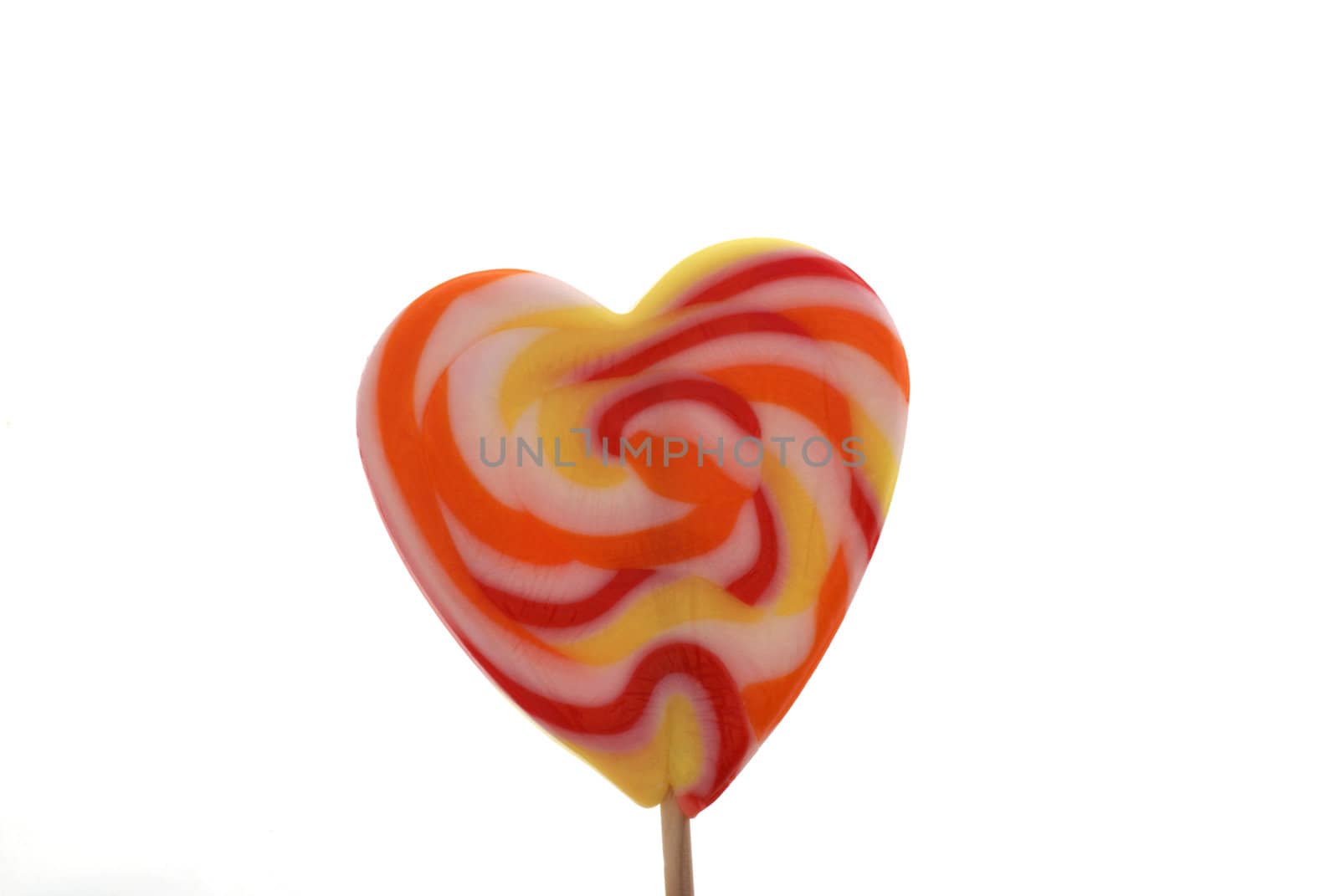 Heart shaped lollypop isolated on white.