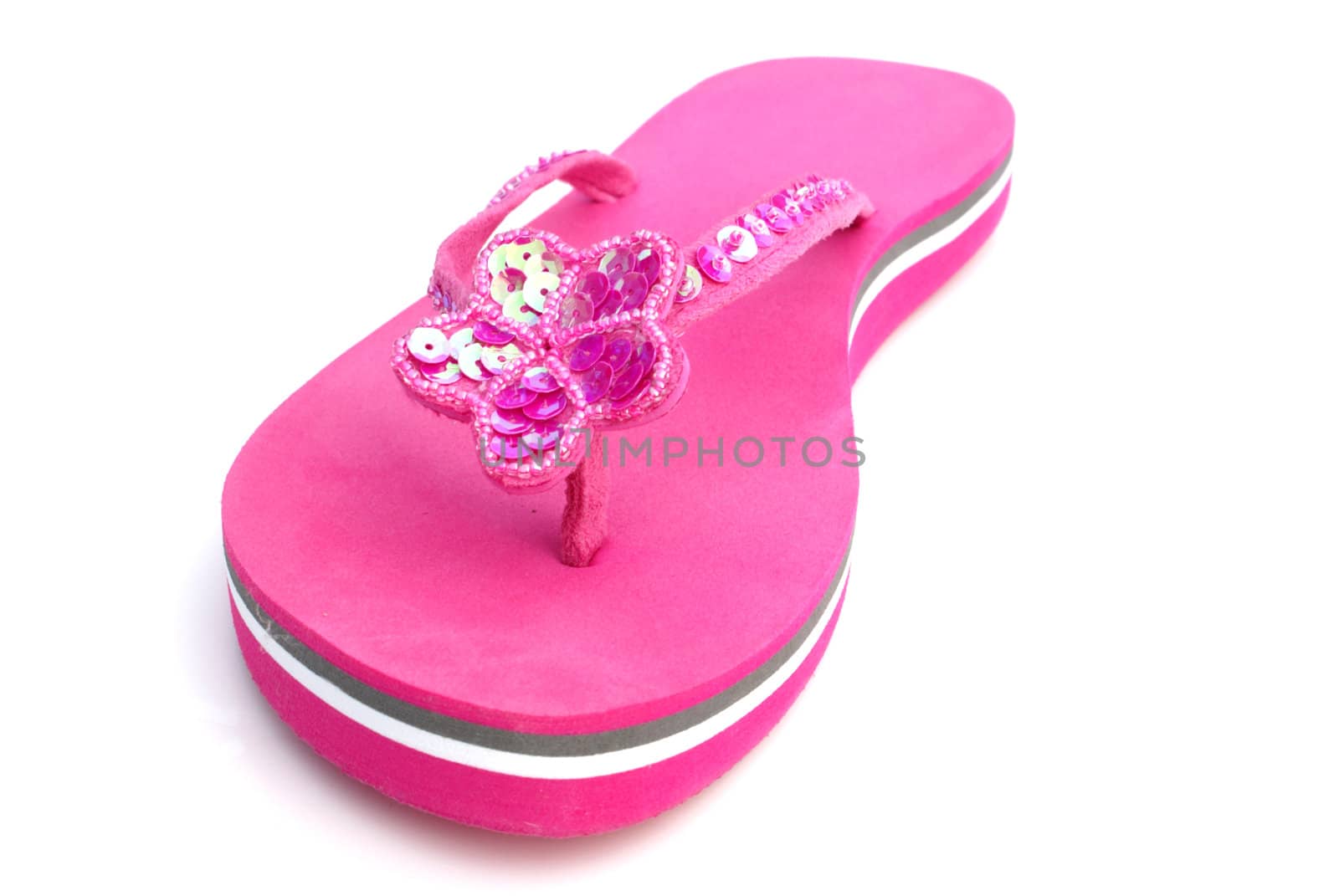 Pink summer footwear against white background.