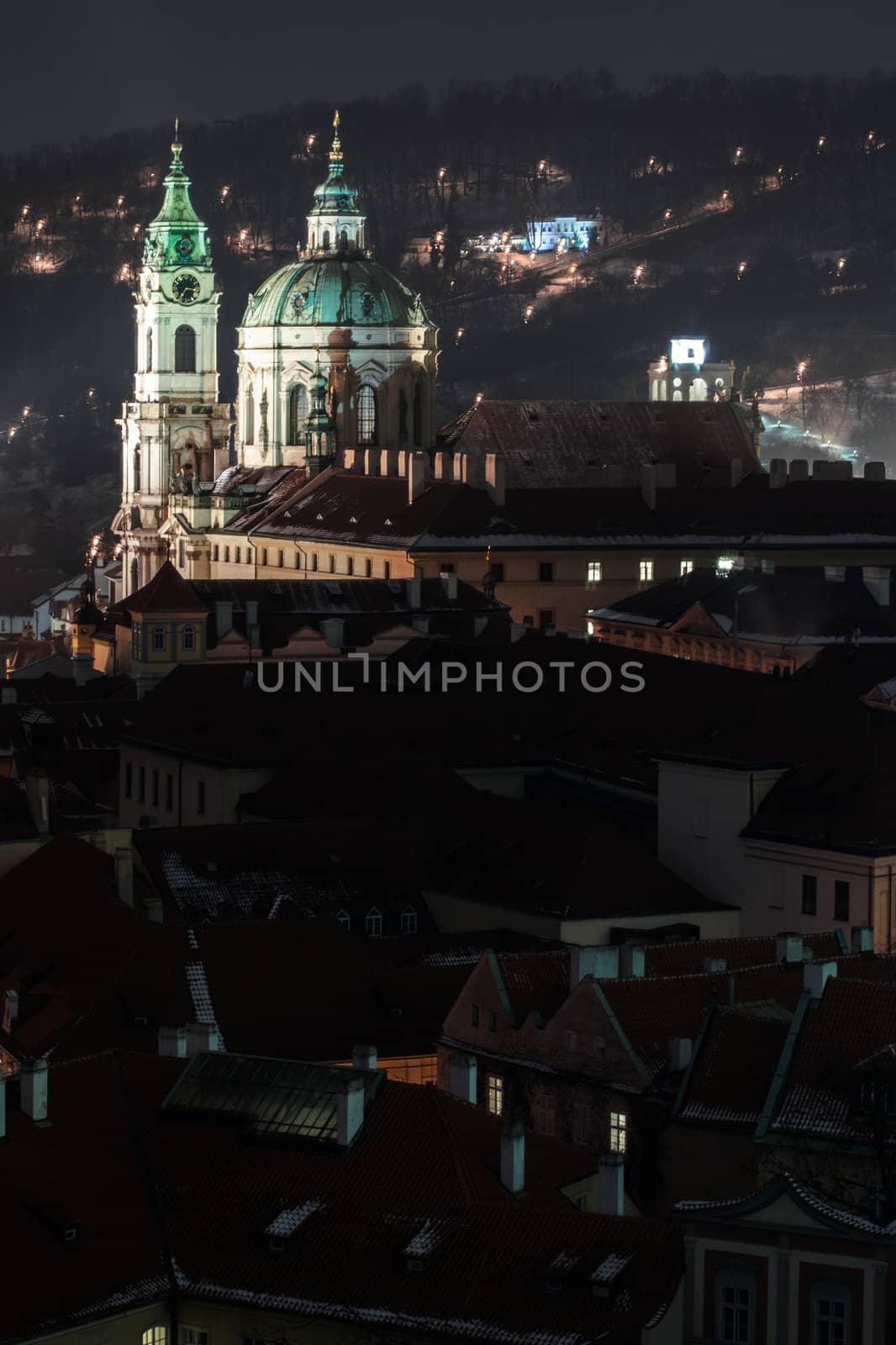 illuminated St. Nicholas church at night, Prague, Czech Republic