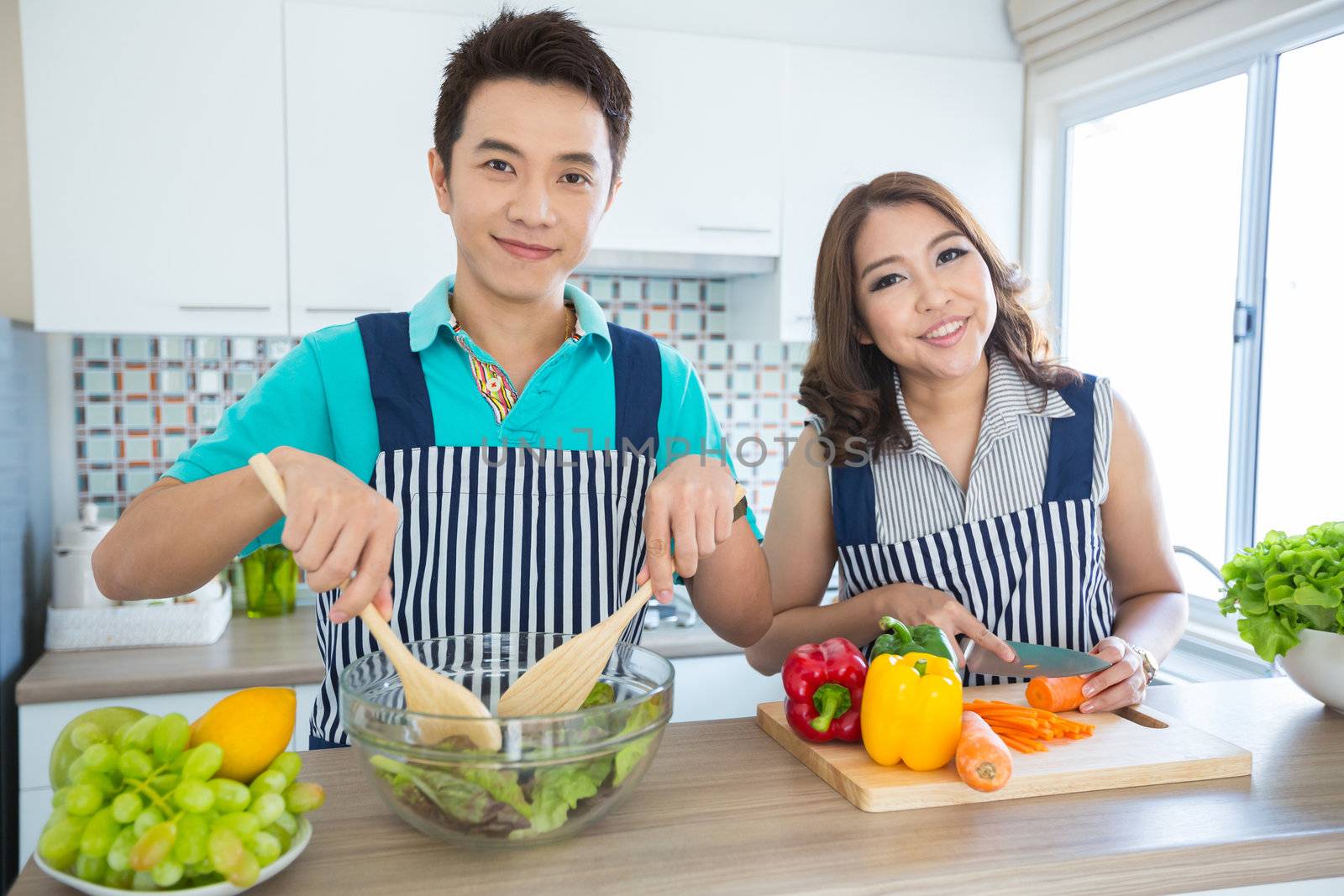 Young happy couples in domestic kitchen