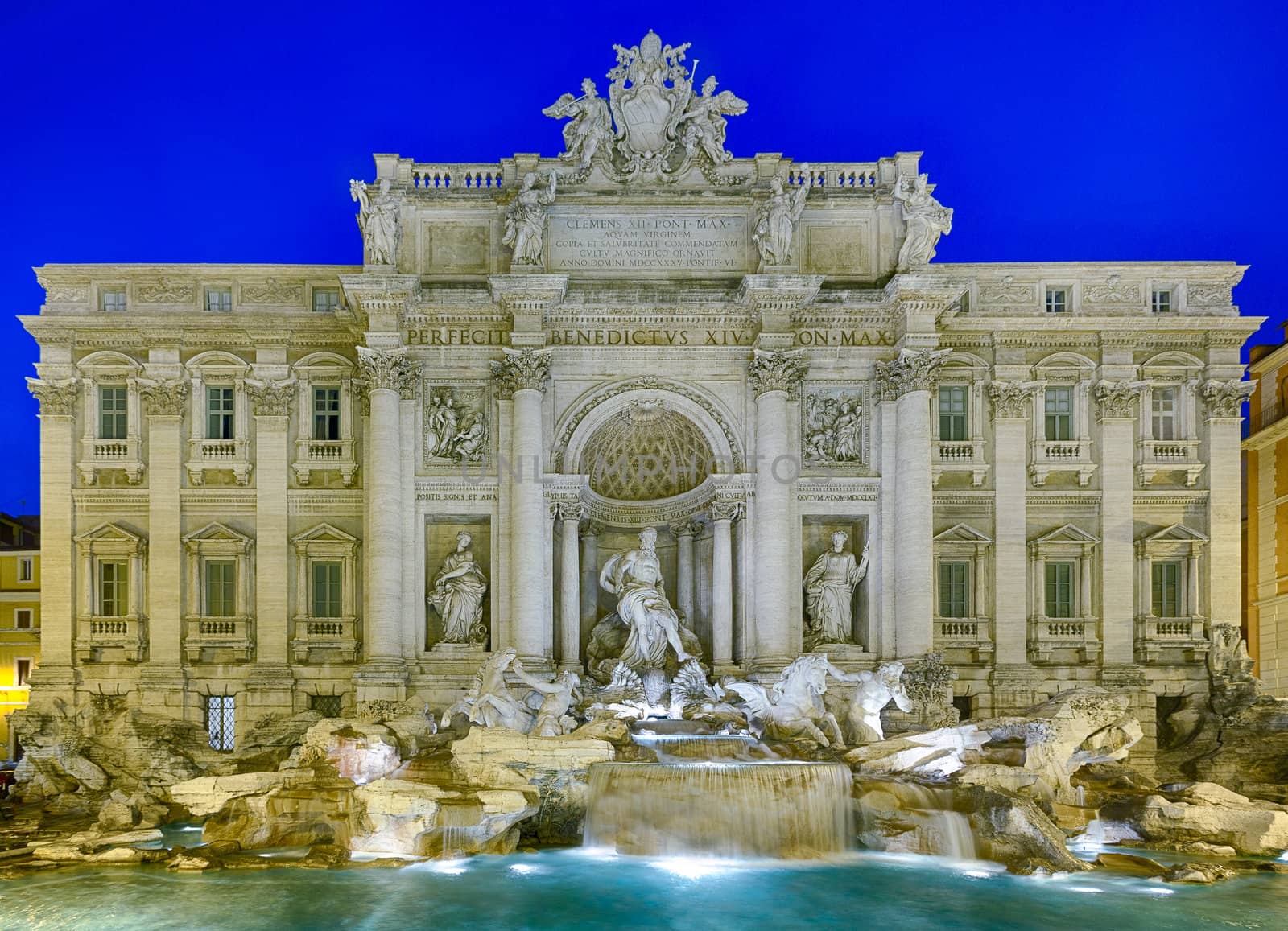 Night time floodlit details of statues in Trevi fountain in Rome Italy