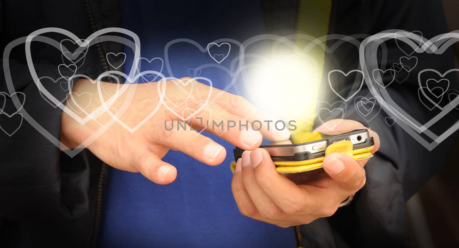 Hand of business man send heart on mobile phone as Valentine concept
