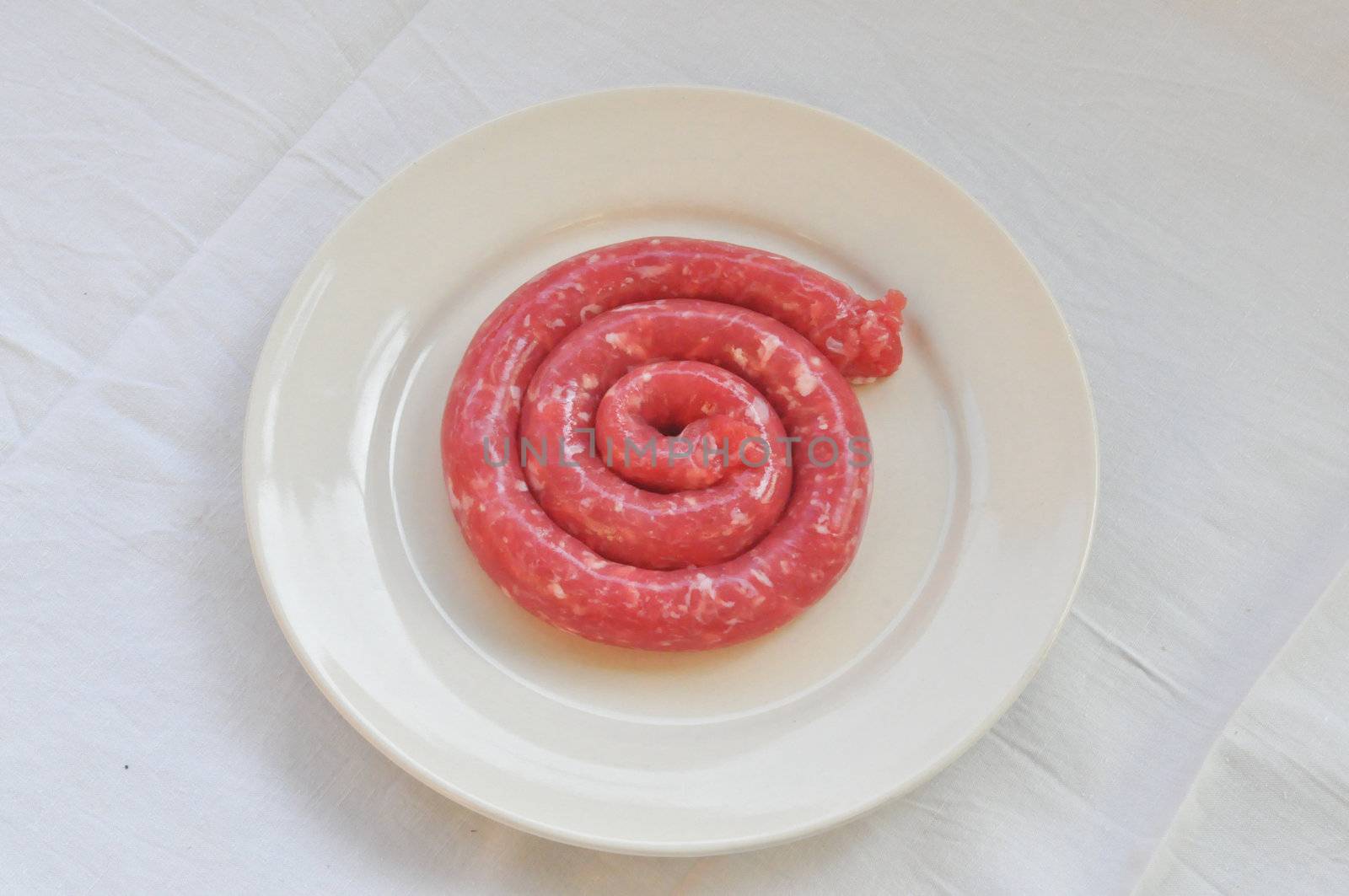 Detail of beef sausage in a dish