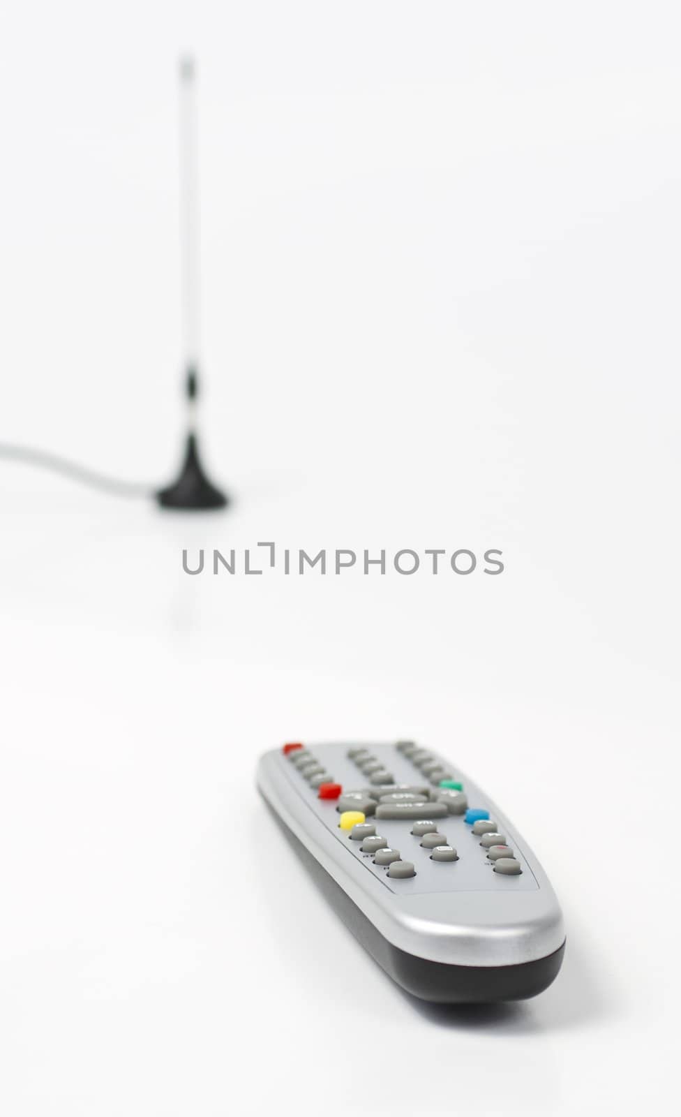 plastic remote control and antenna in backround. Depth of field. Colored keys on remote control